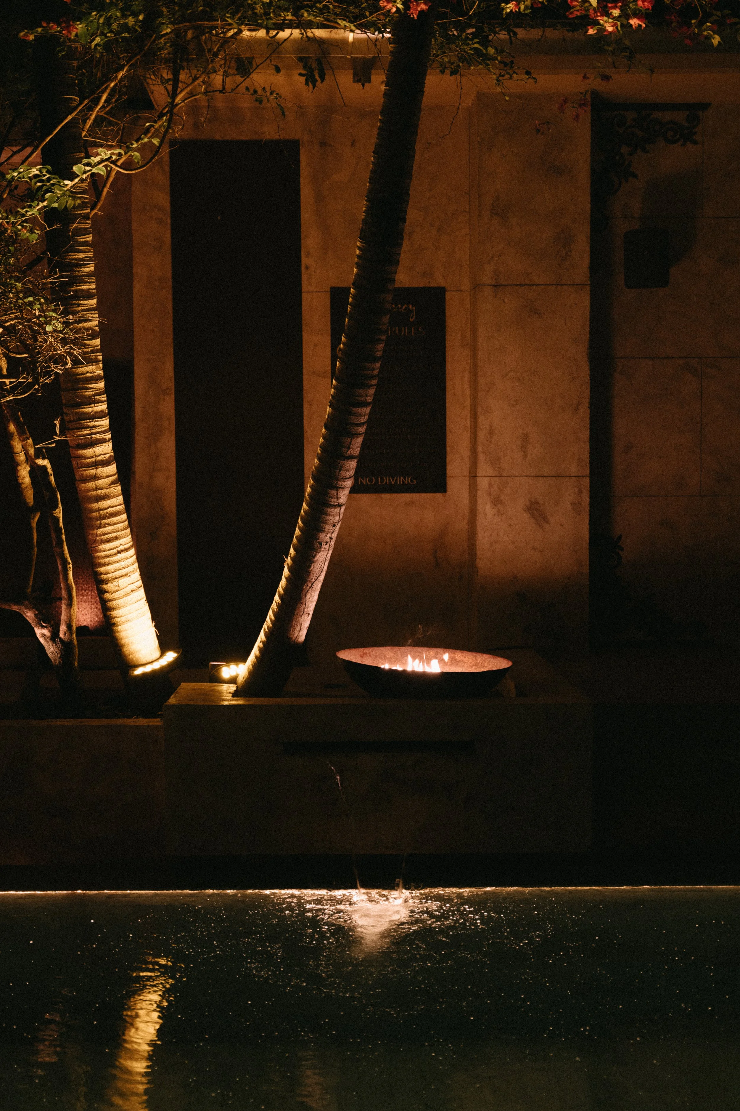 Illuminated tropical garden and pool area at night at Odyssey Mansion, Bangrak Beach, Koh Samui