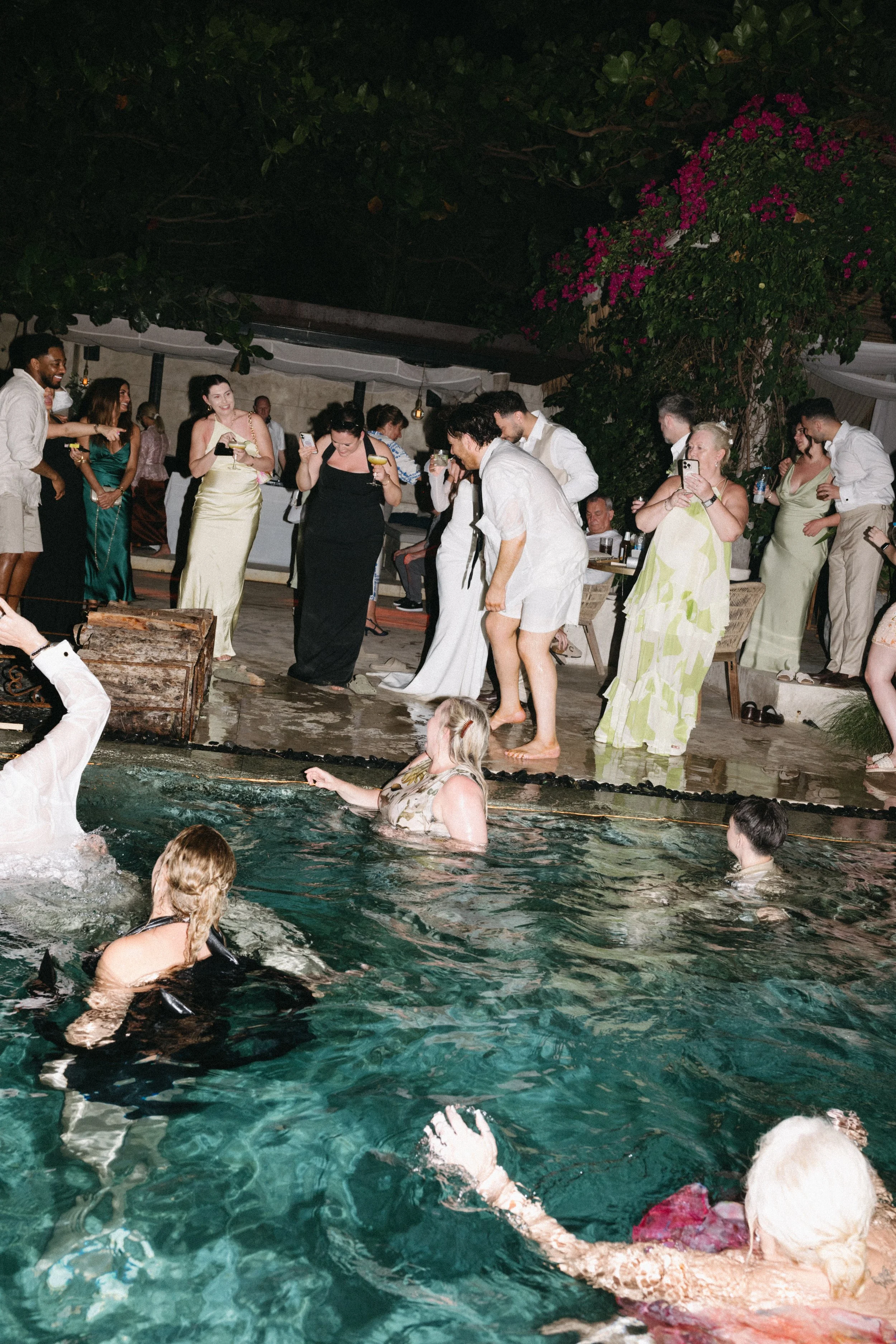 Guests swimming in the pool during a lively destination wedding after-party at Odyssey Mansion, Koh Samui