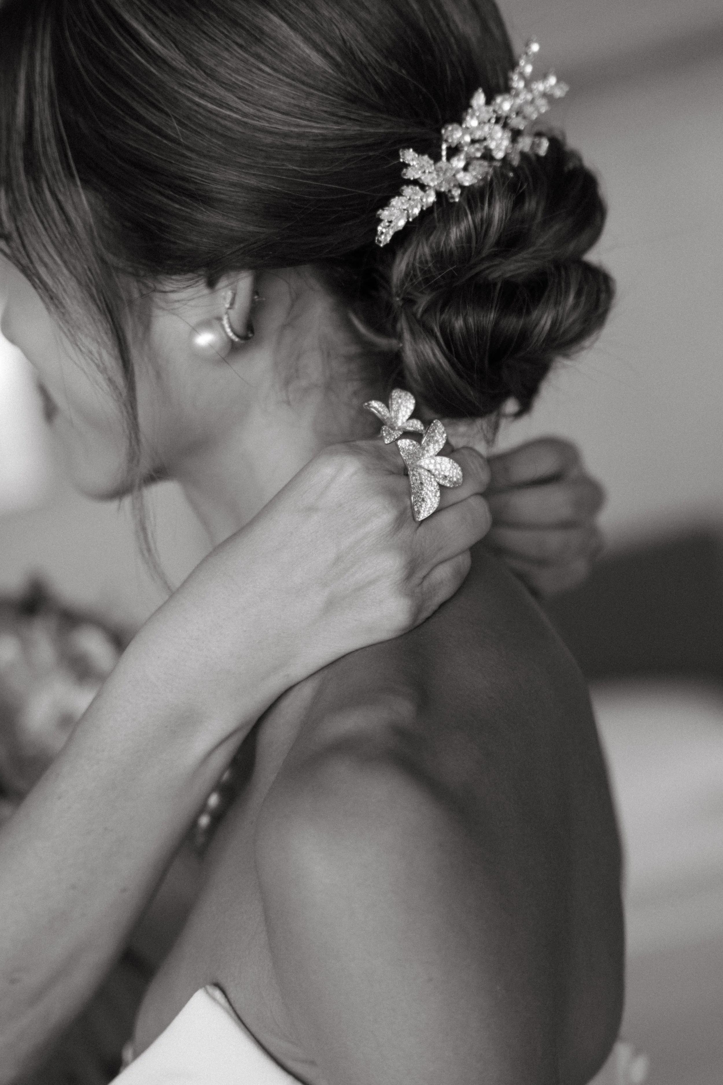 Bride's necklace being adjusted before her Phuket destination wedding, black and white bridal prep photo