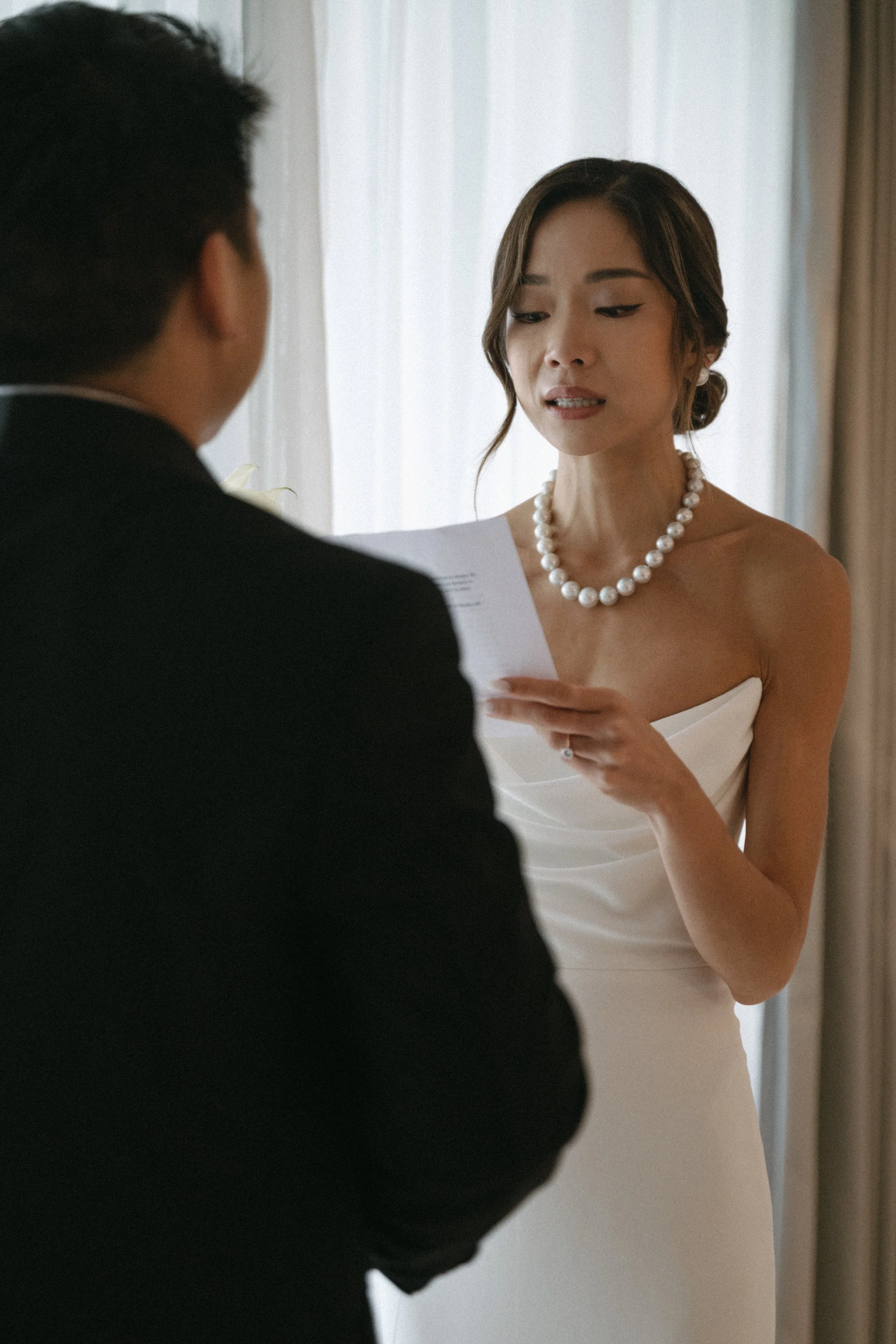bride reading vows to groom during private vows at COMO Point Yamu, Phuket