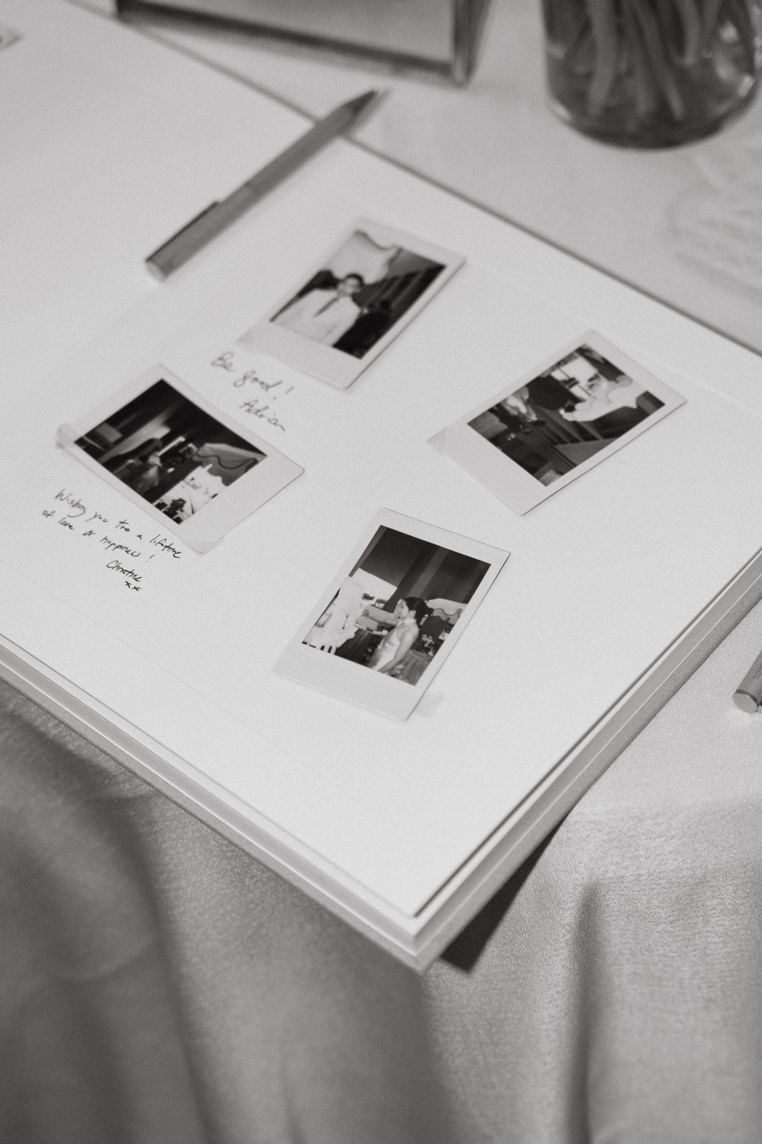 Polaroid photos laid out on guest welcome table, documentary detail shot