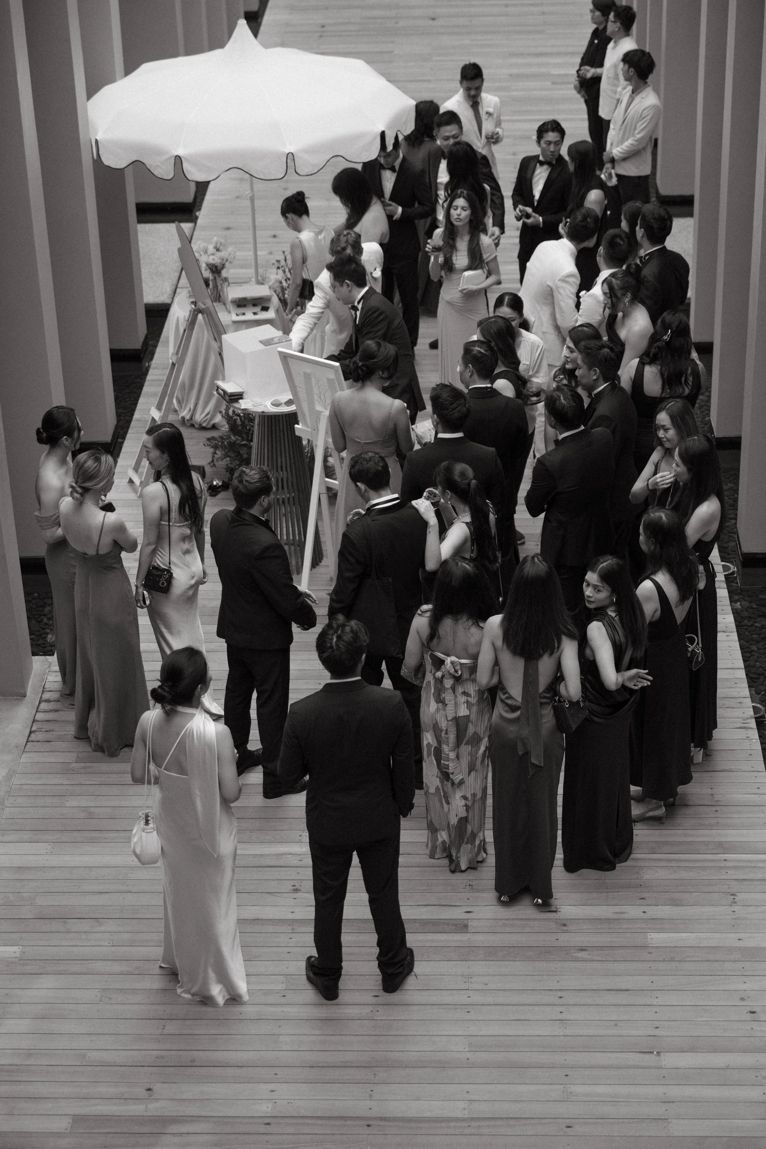 Wedding guests arriving and mingling at COMO Point Yamu, black and white candid photo