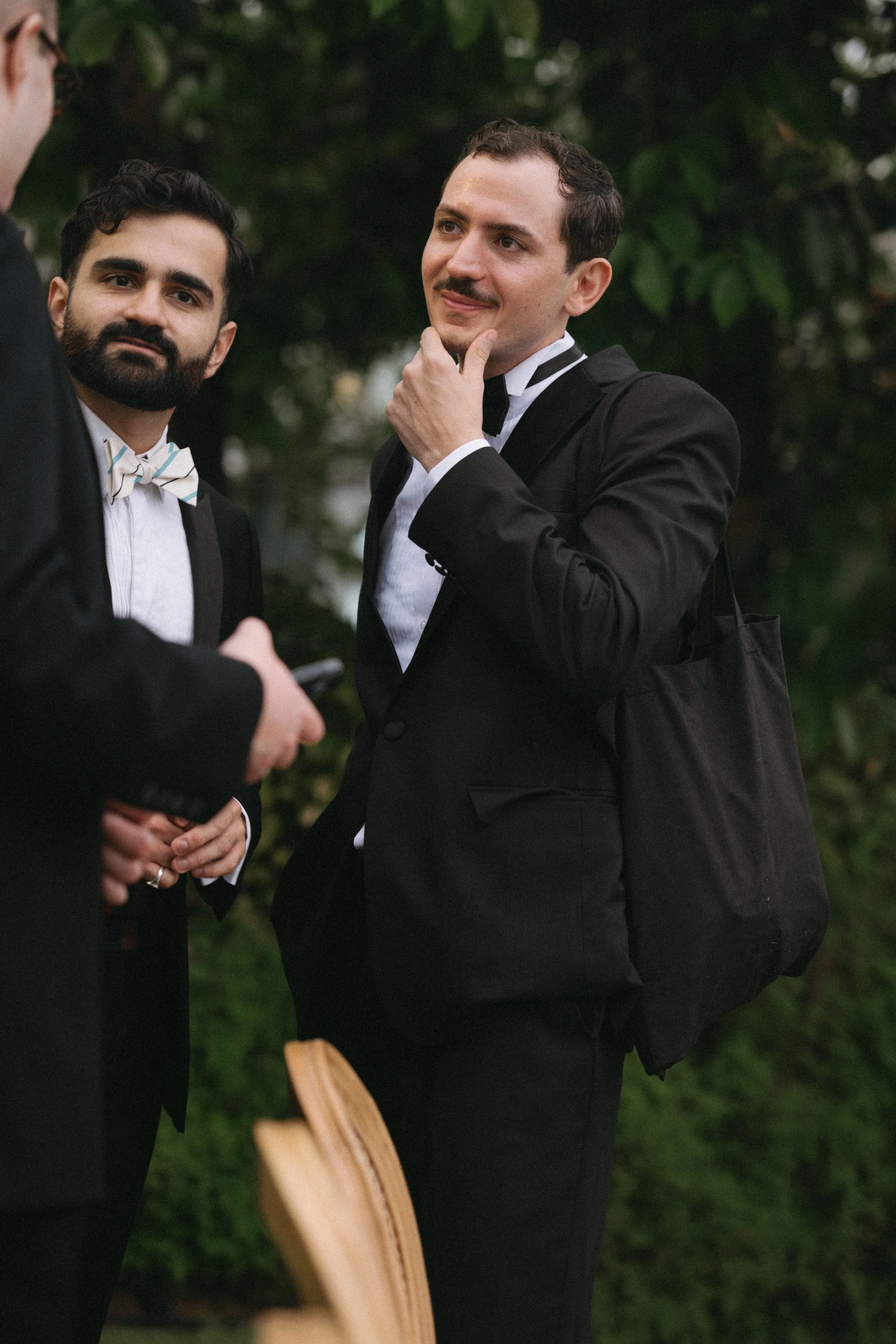 Male guests in suits talking with each other warmly at COMO Point Yamu welcome drinks