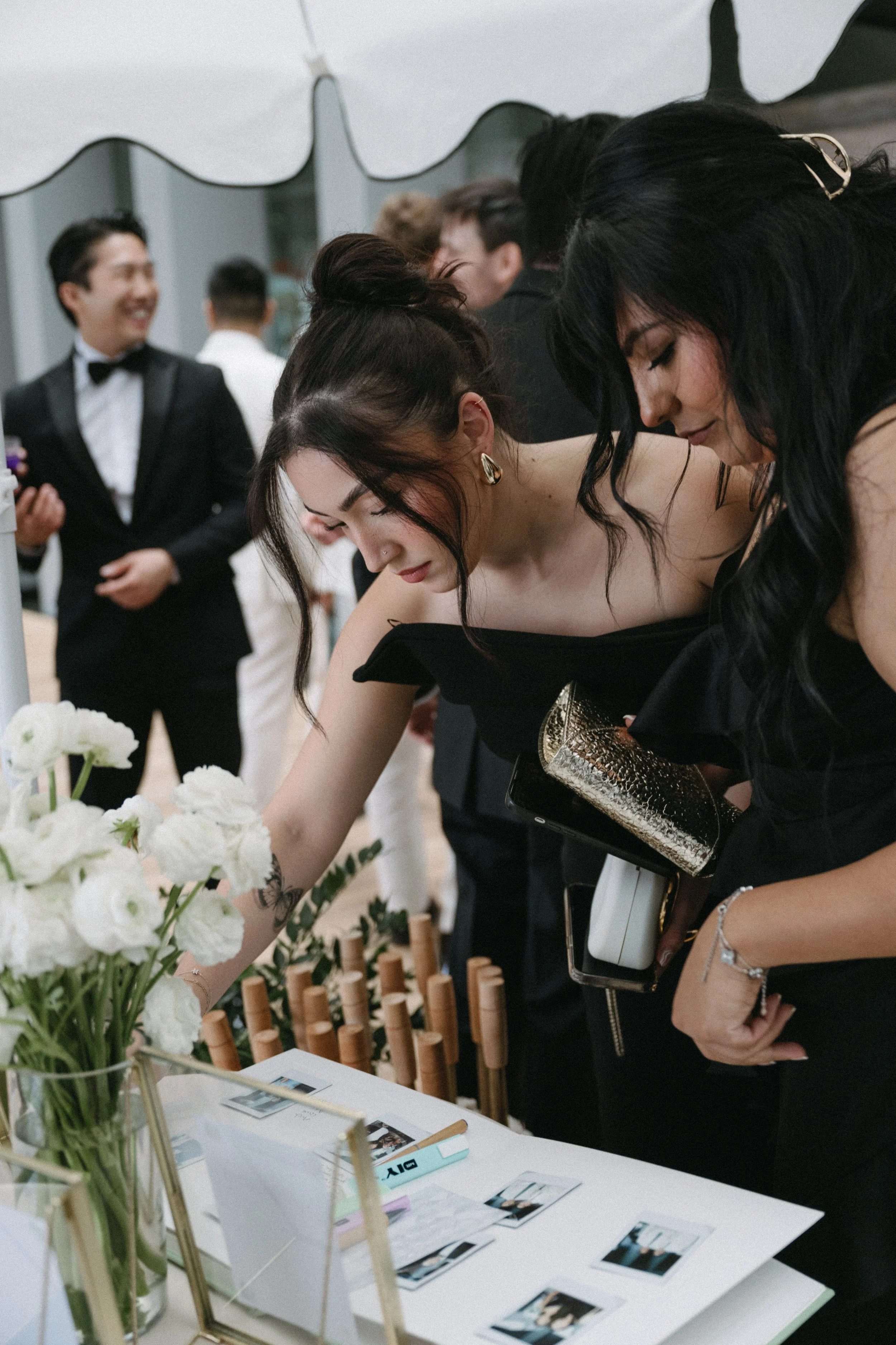 Guests writing in guest book at welcome table before Phuket wedding ceremony
