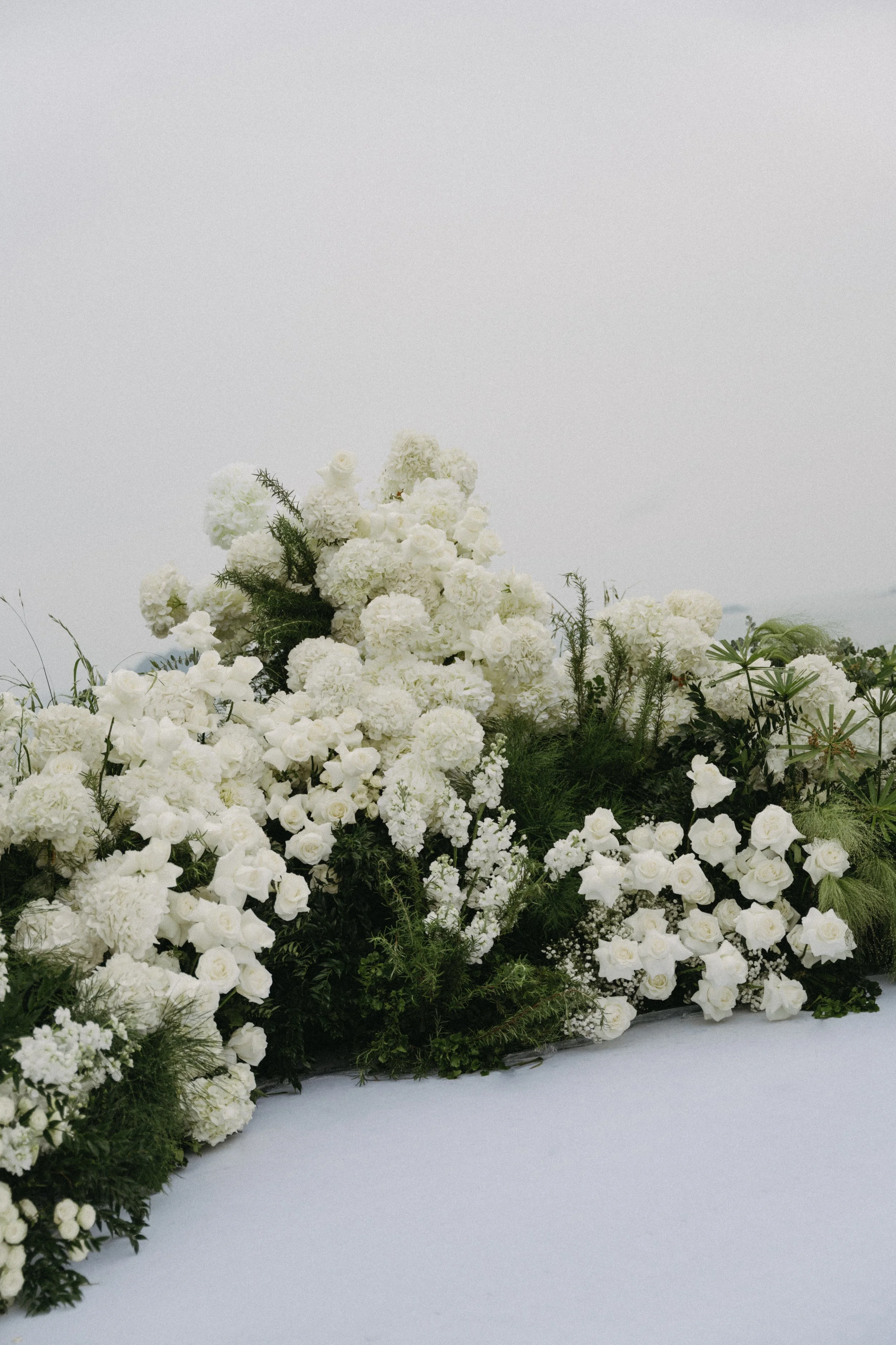 Close-up of white hydrangea and rose florals, Phuket wedding ceremony detail shot