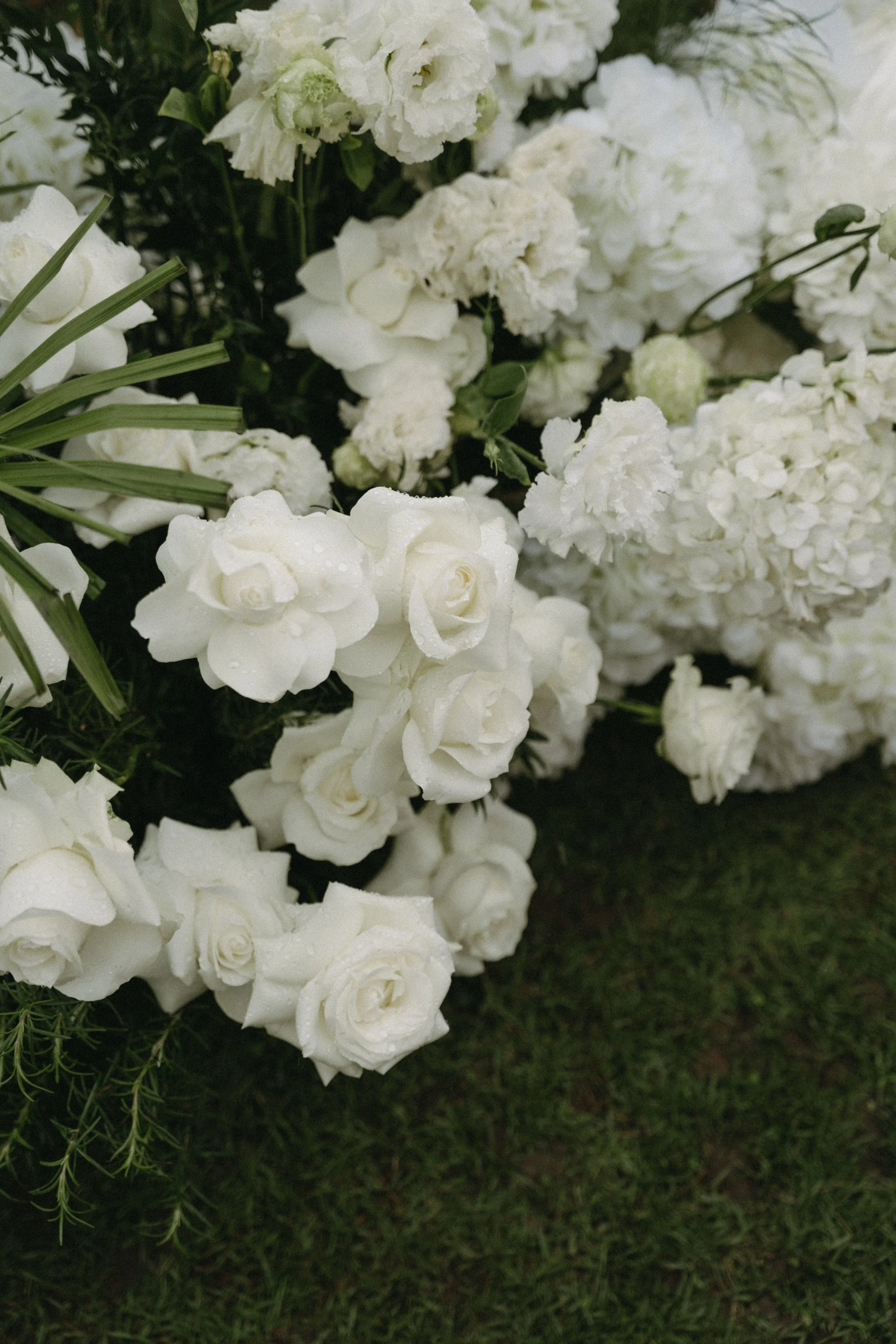 Close-up of white hydrangea and rose wedding ceremony florals