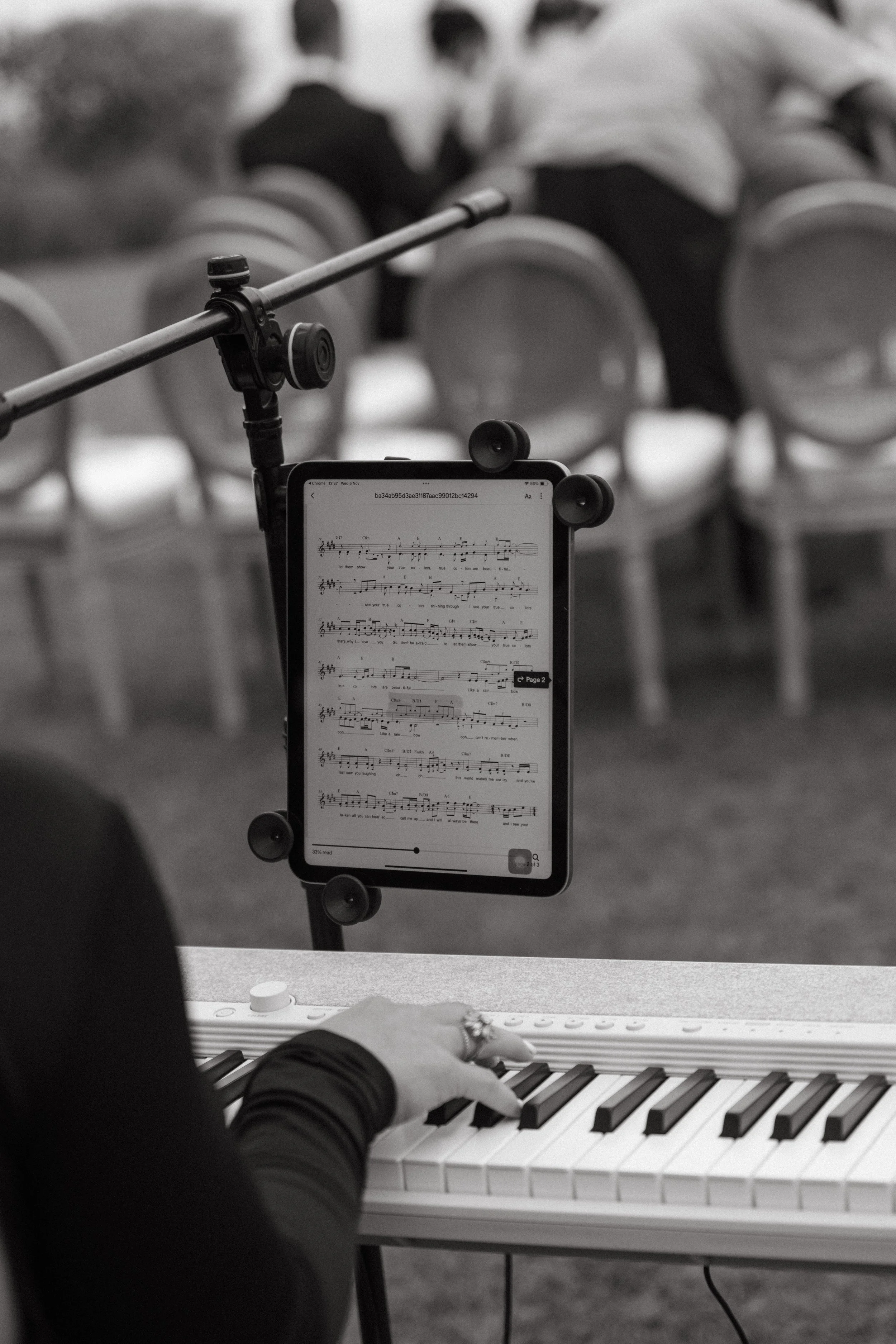 Close-up of sheet music and piano keys, live ceremony music detail shot