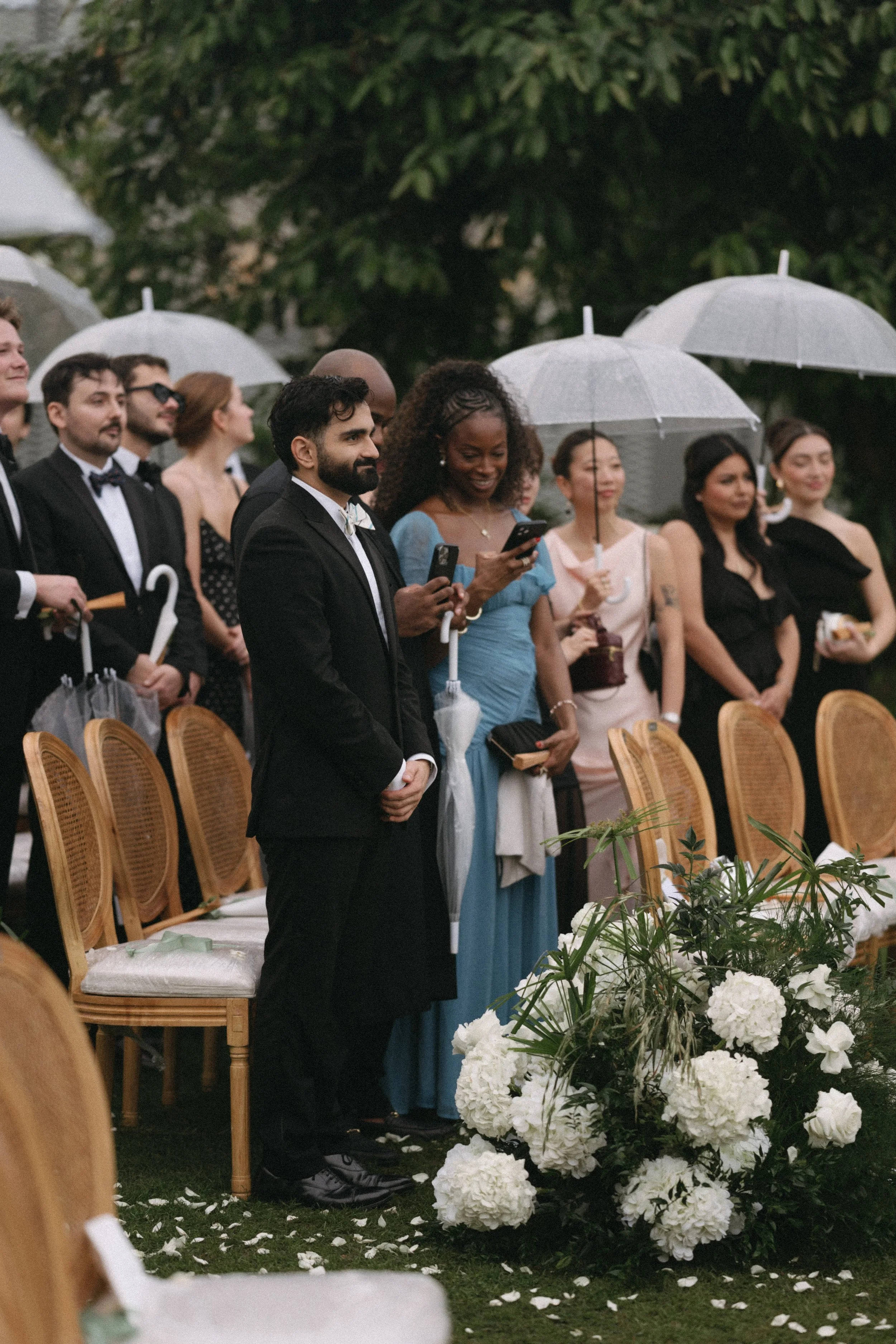 Wedding guests standing at outdoor ceremony at como point yamu in phuket