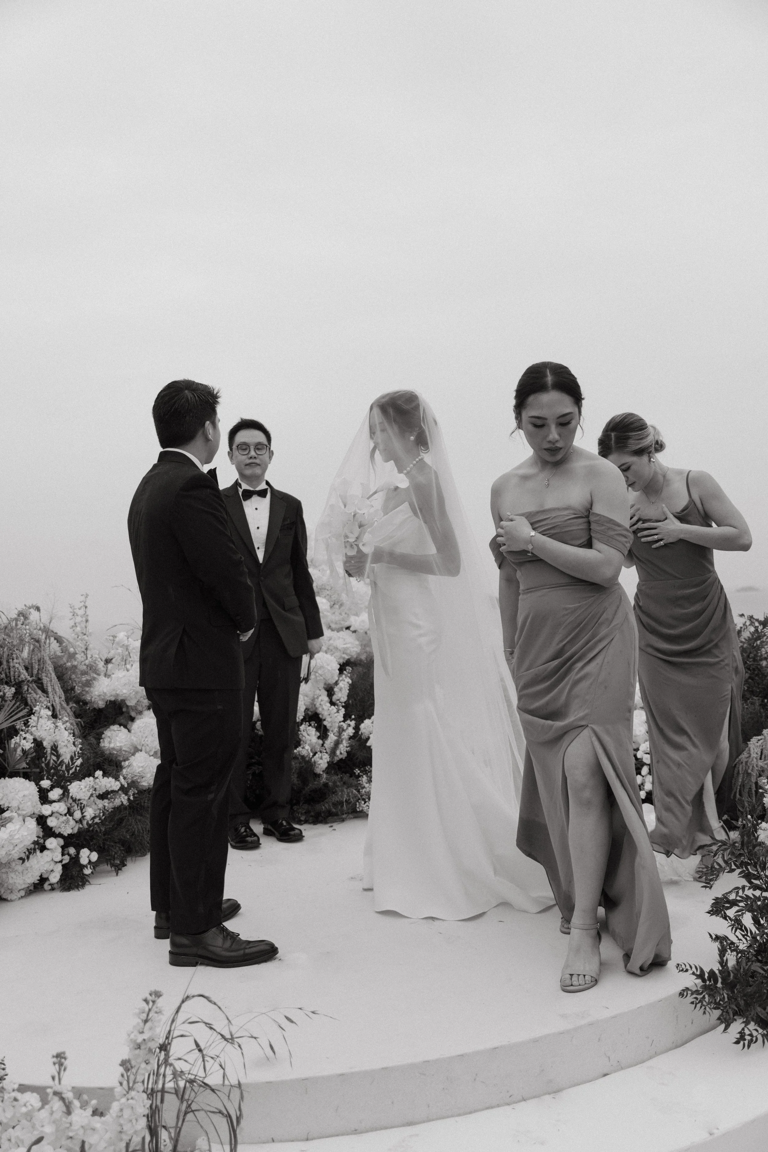 Bride and groom standing on circular ceremony platform overlooking Phang Nga Bay