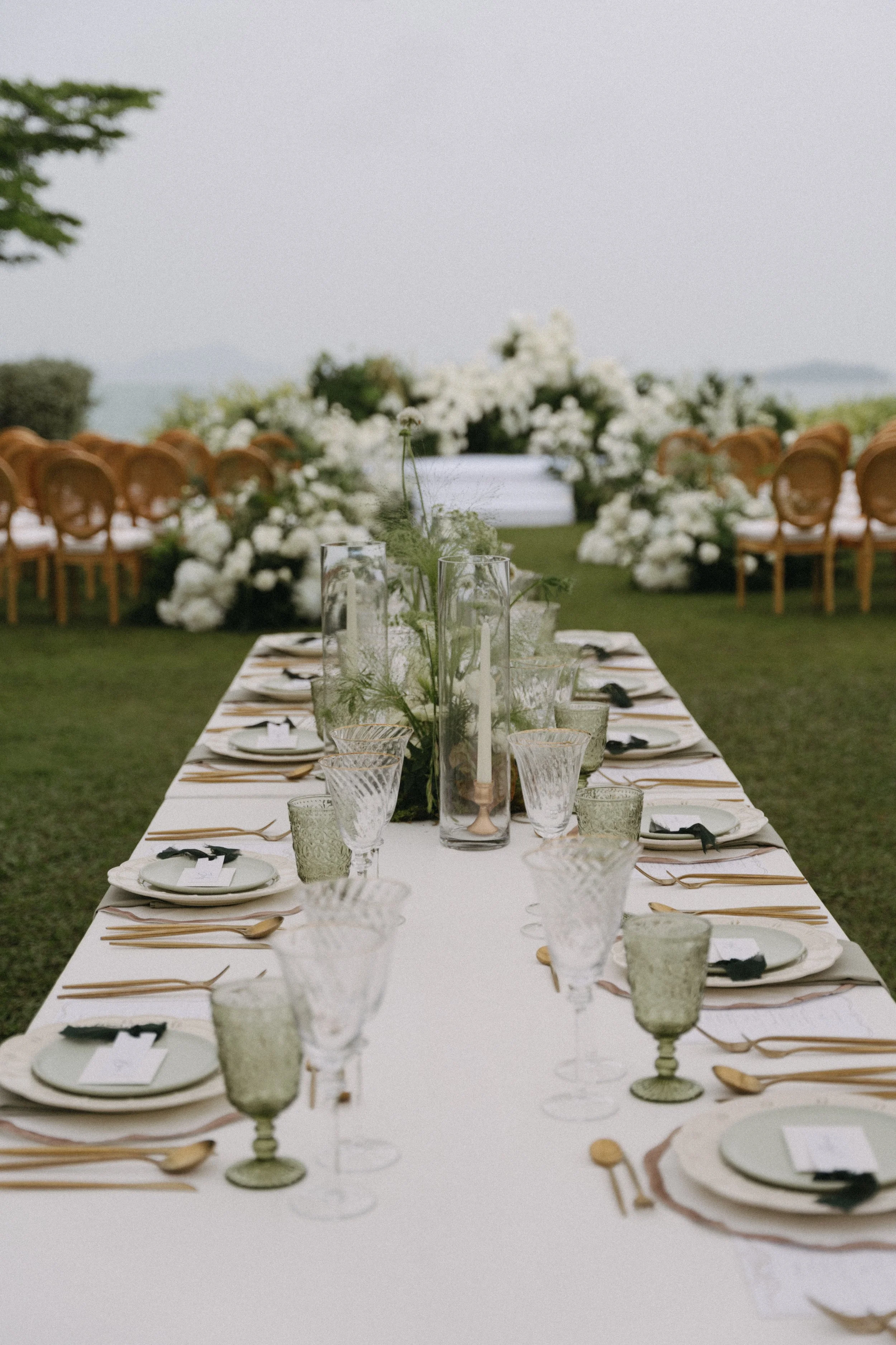 Long reception table setup with ocean view at COMO Point Yamu