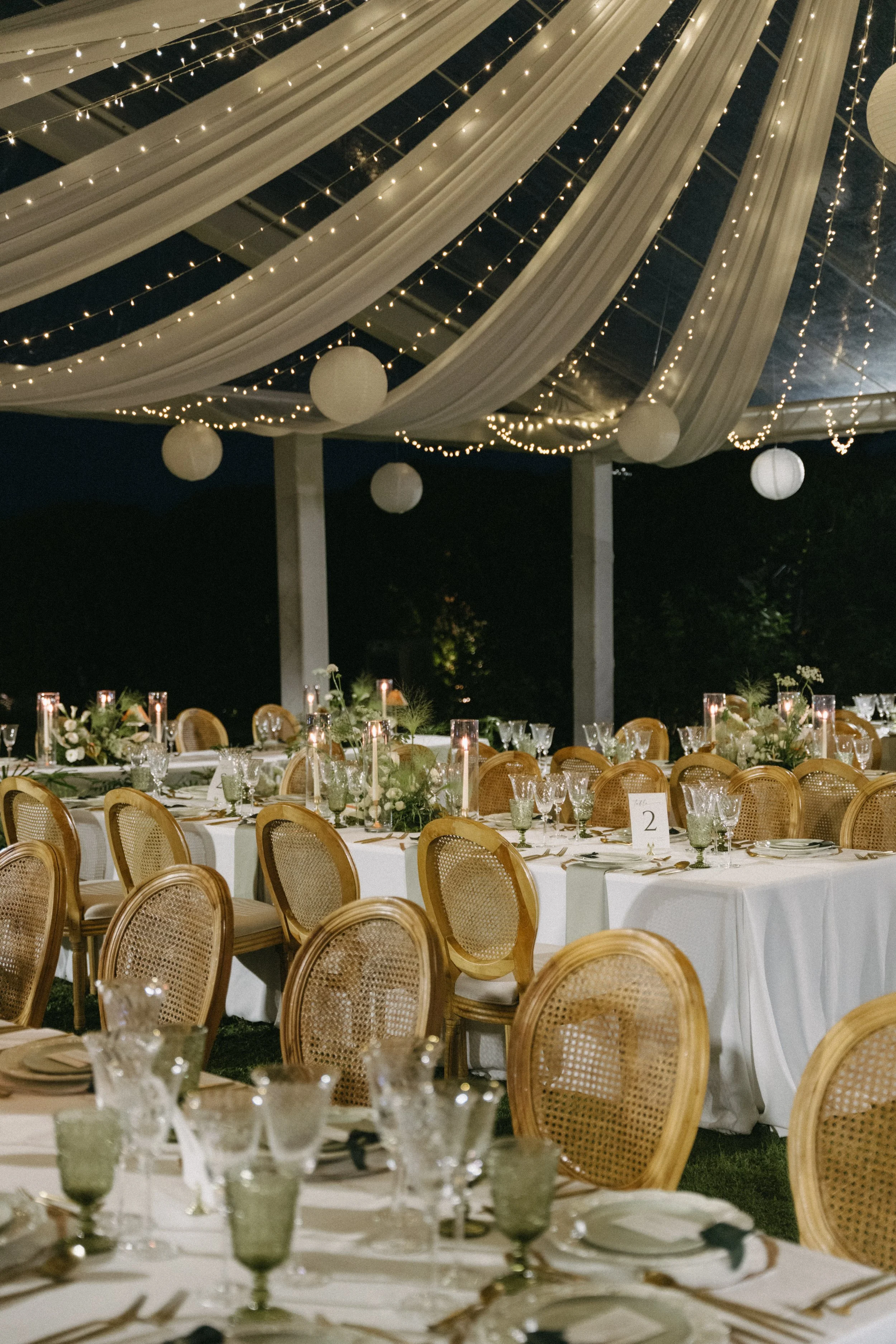 marquee tent interior with draped fabrics, lanterns, rattan chairs, evening reception at COMO Point Yamu