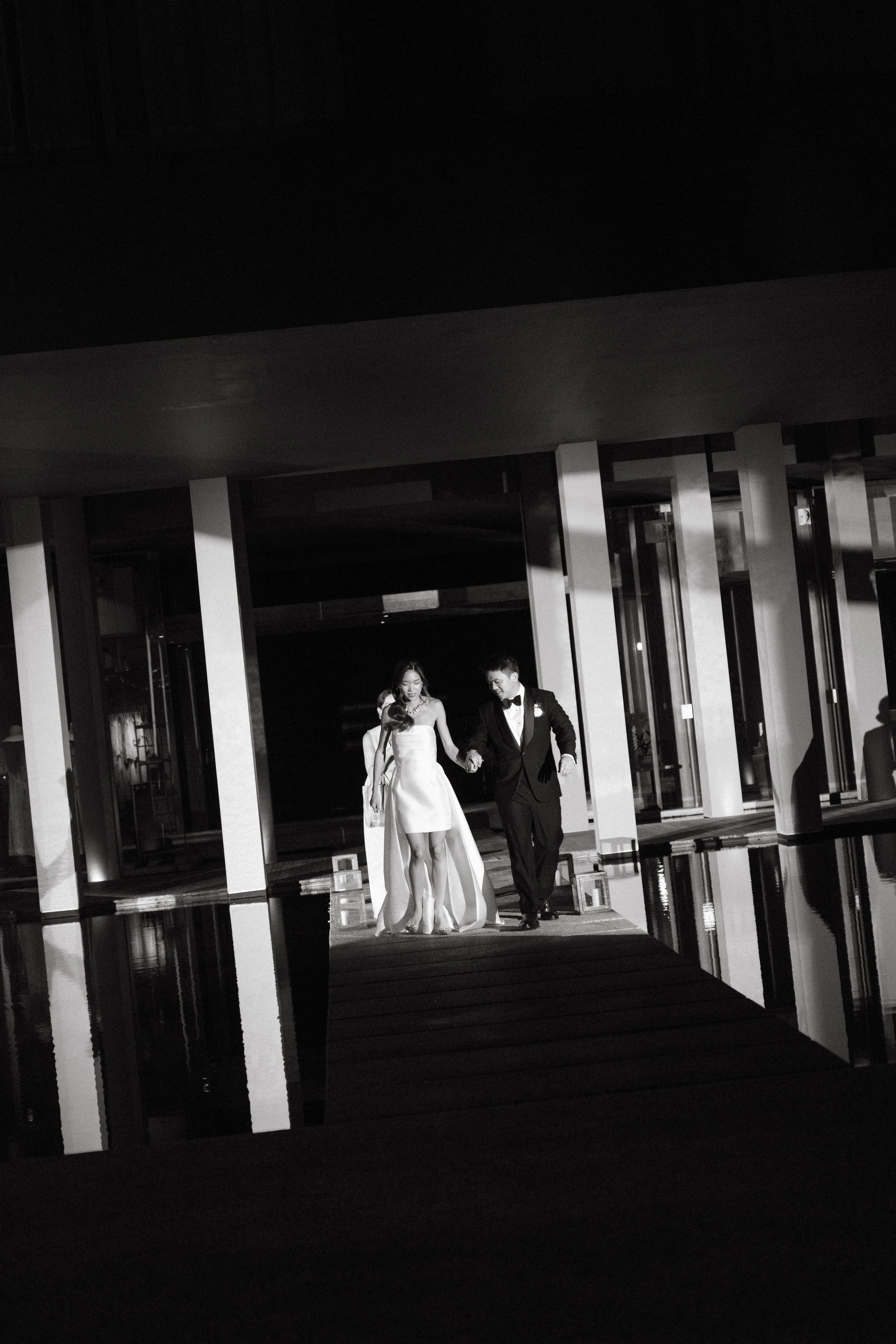 Bride and groom walking hand in hand towards wedding reception at COMO Point Yamu
