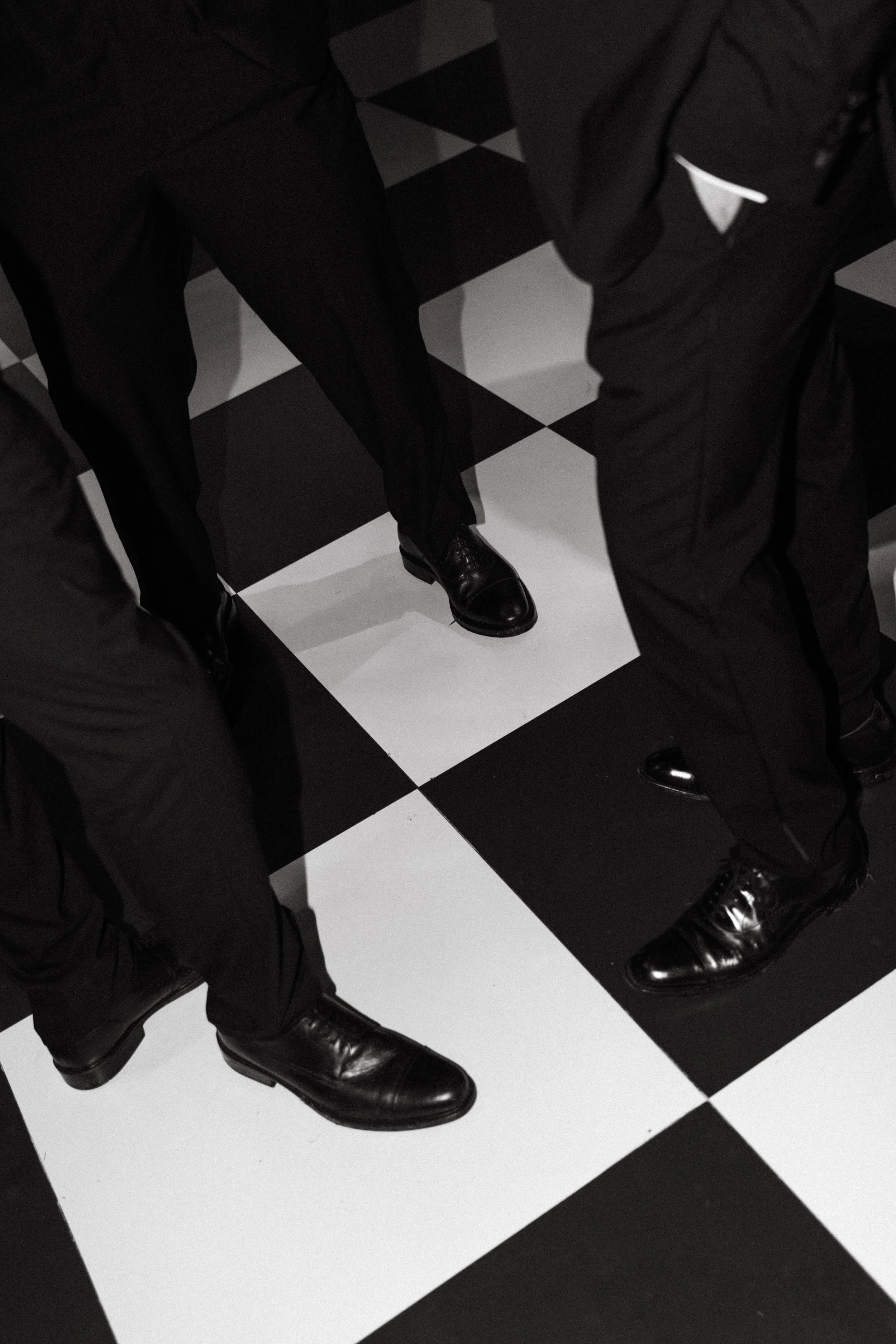 Wedding guests dancing on black and white checkered dance floor