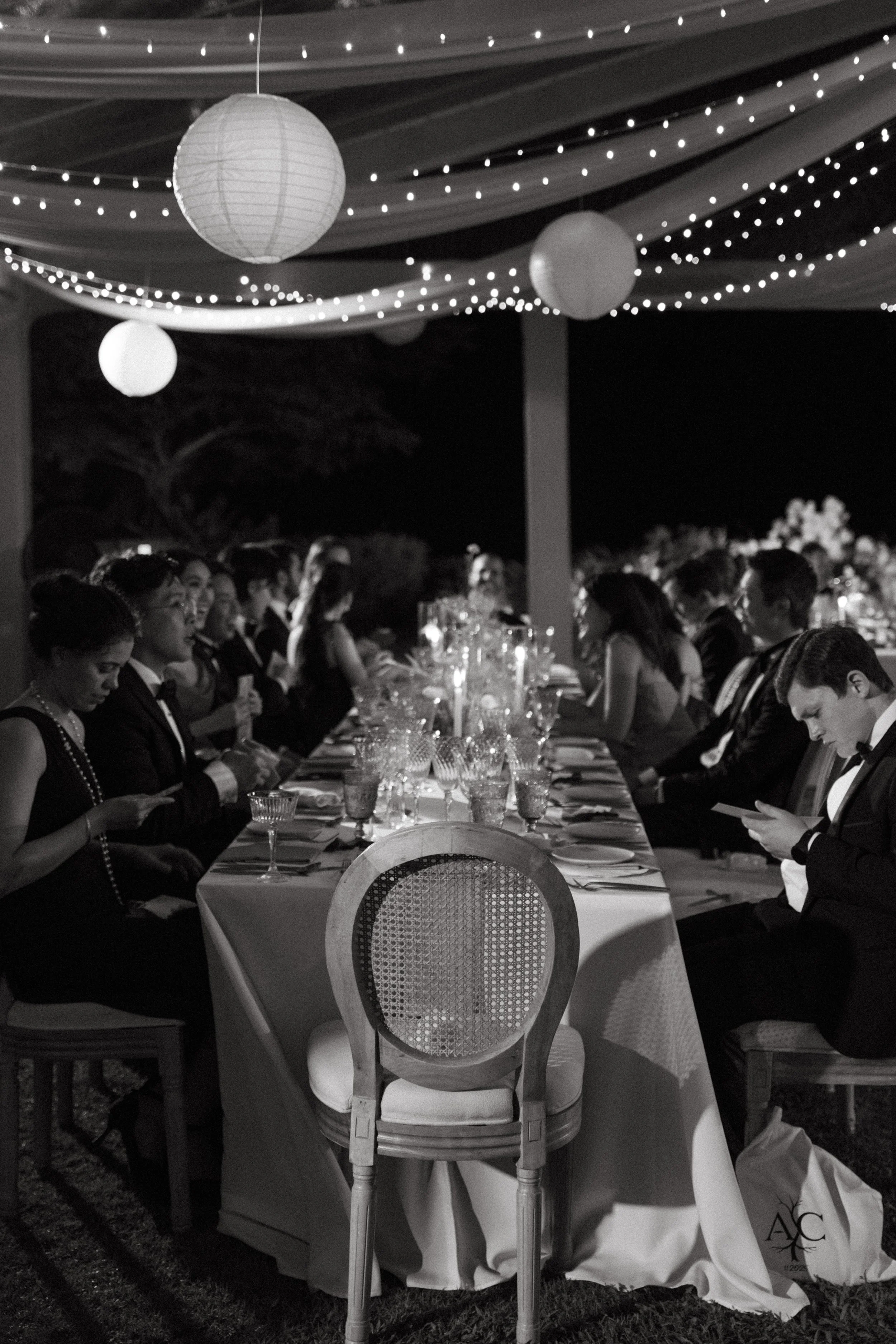 Long reception table set for dinner under string lights at COMO Point Yamu