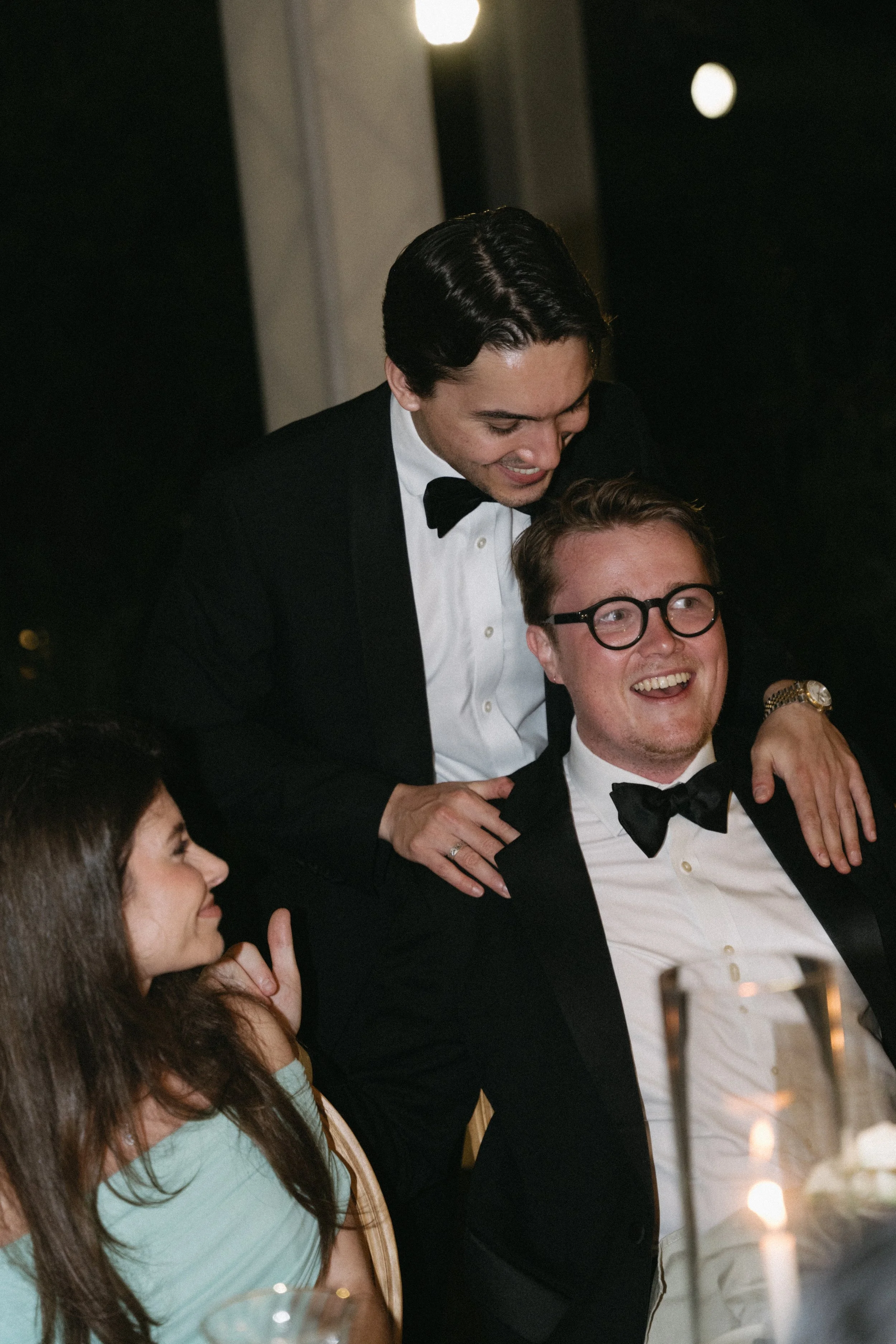 candid portrait of  guest laughing together during reception speeches