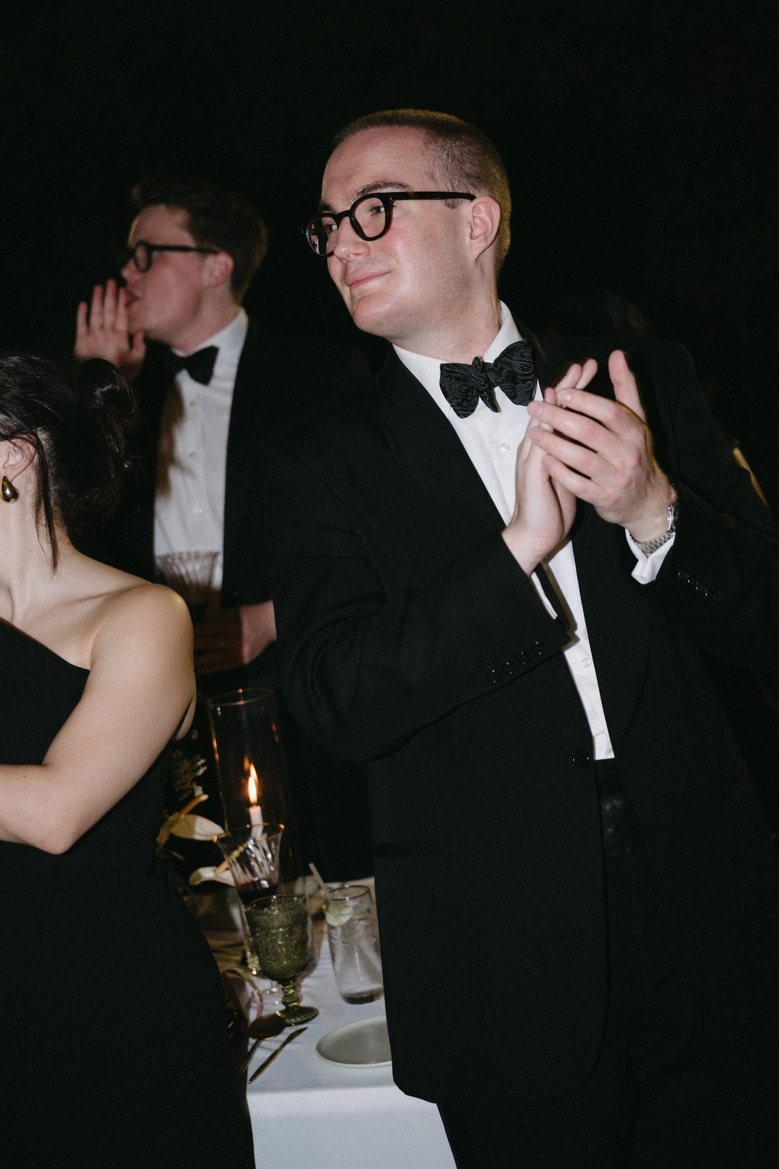 Guests in black tie clapping and celebrating on the dance floor