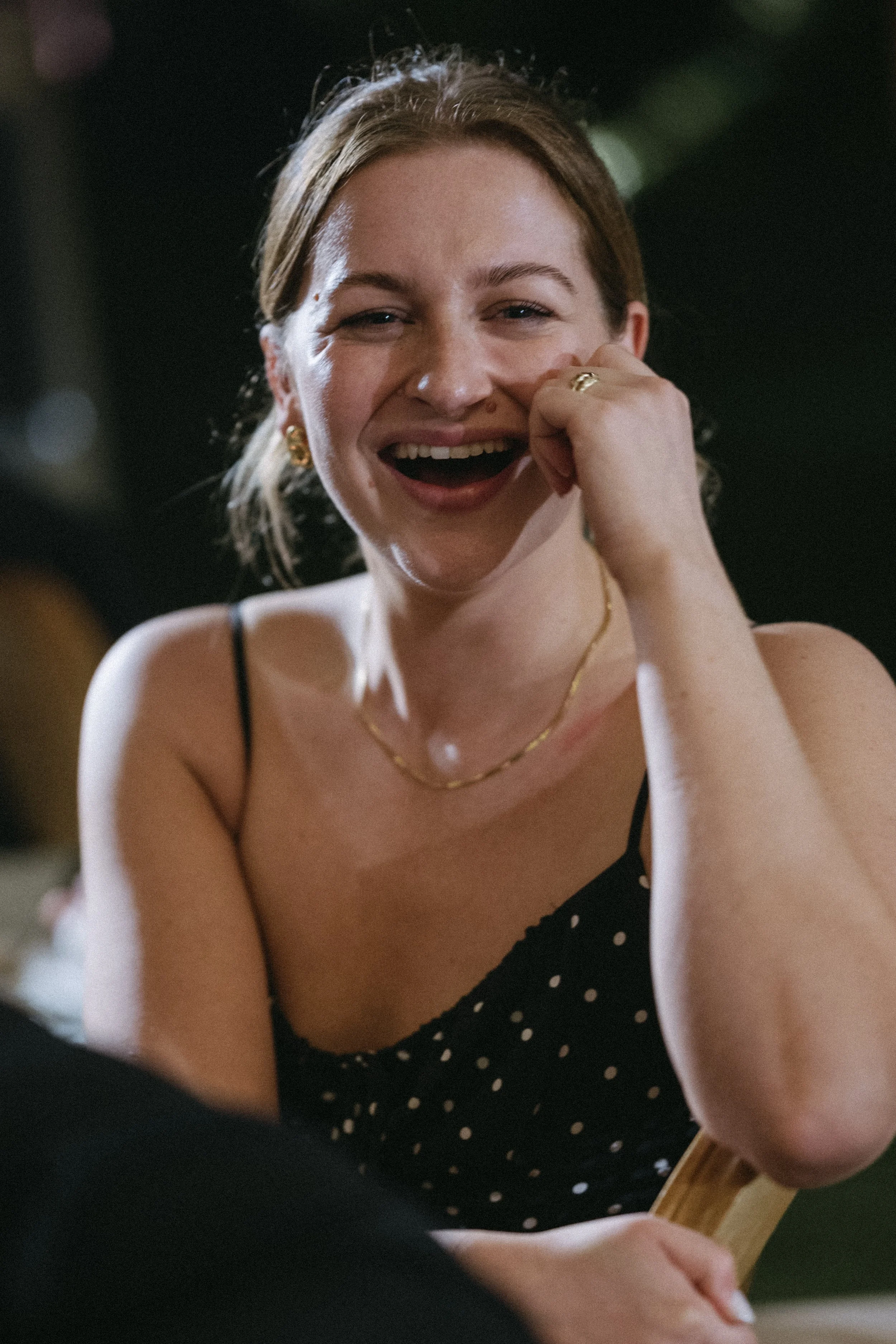 Female guest laughing during reception speech