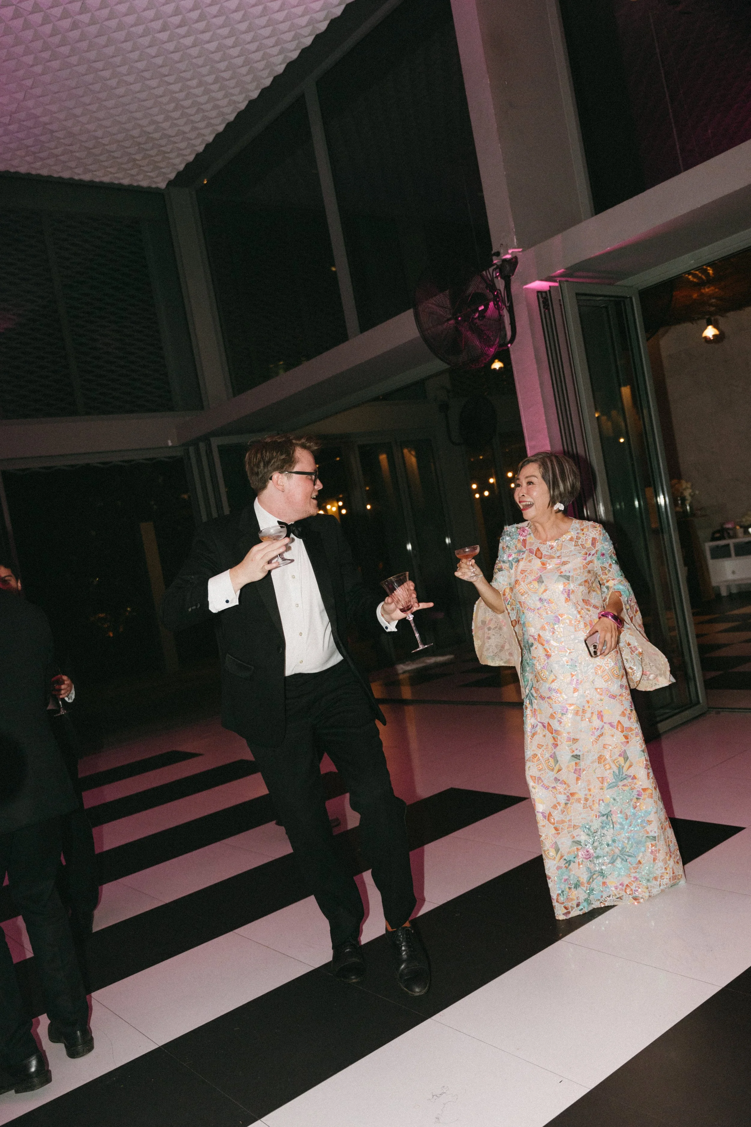 Guests mingling on dancefloor at night reception