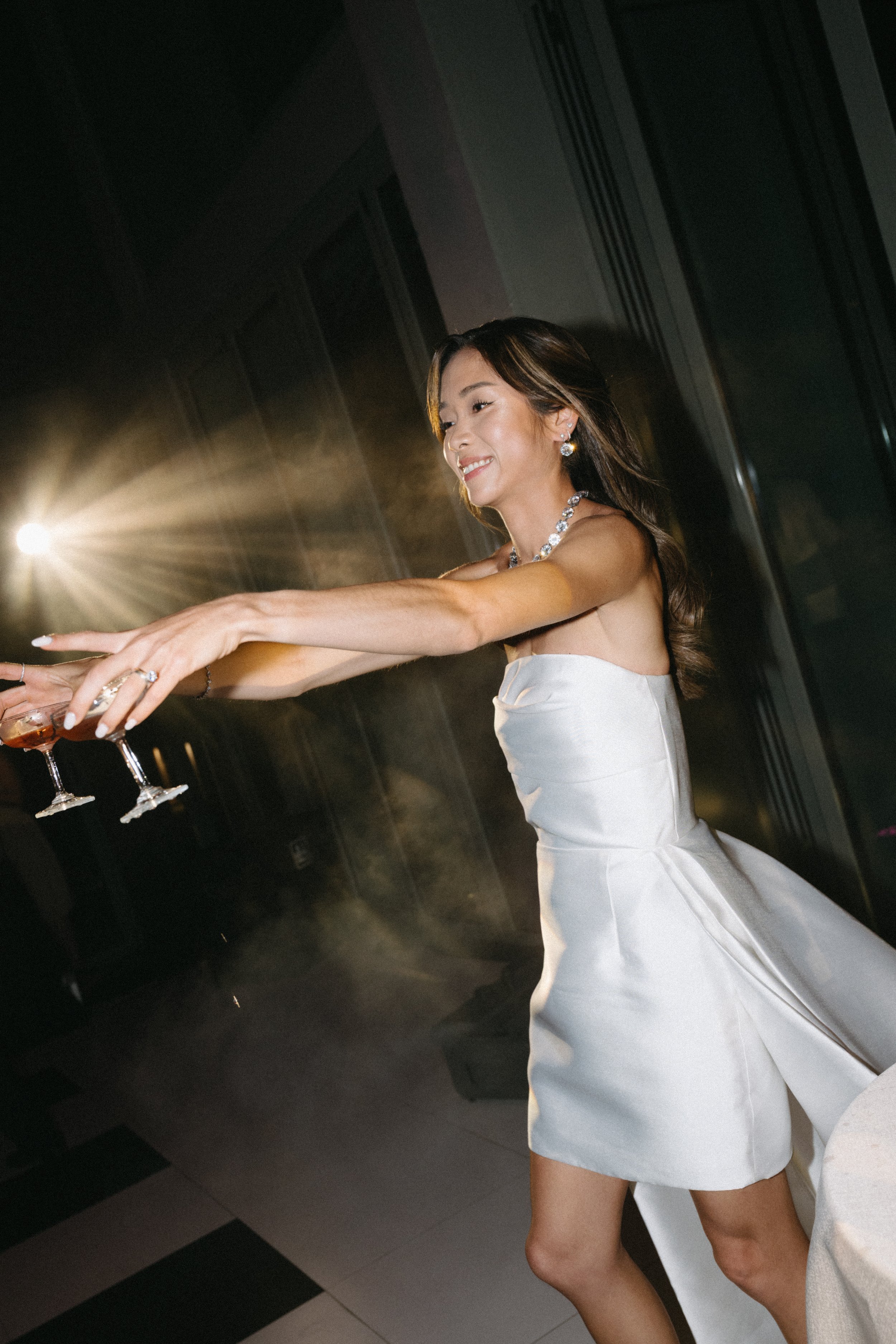bride holding two champagne glasses