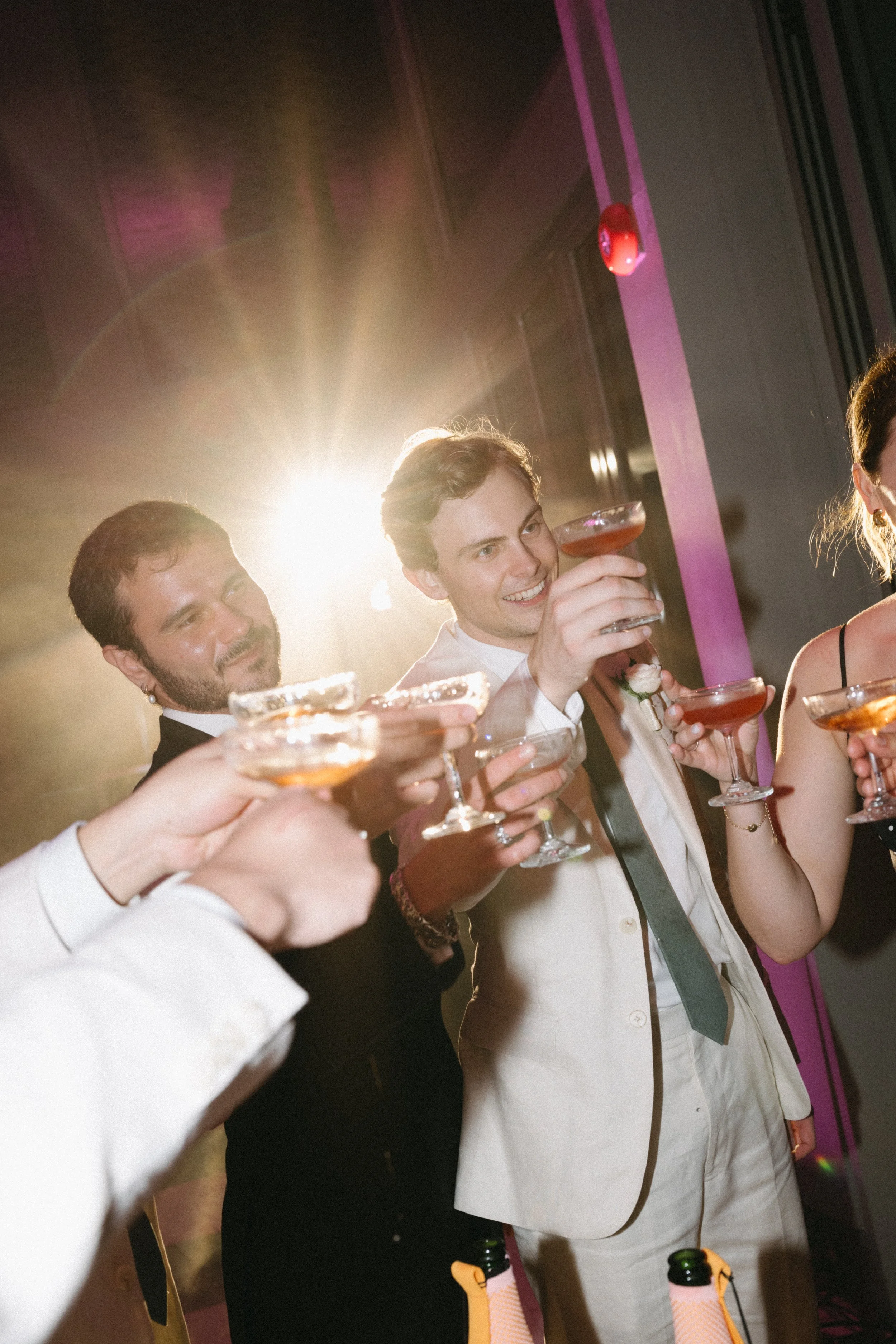 Guests clinking champagne glasses together in celebratory toast