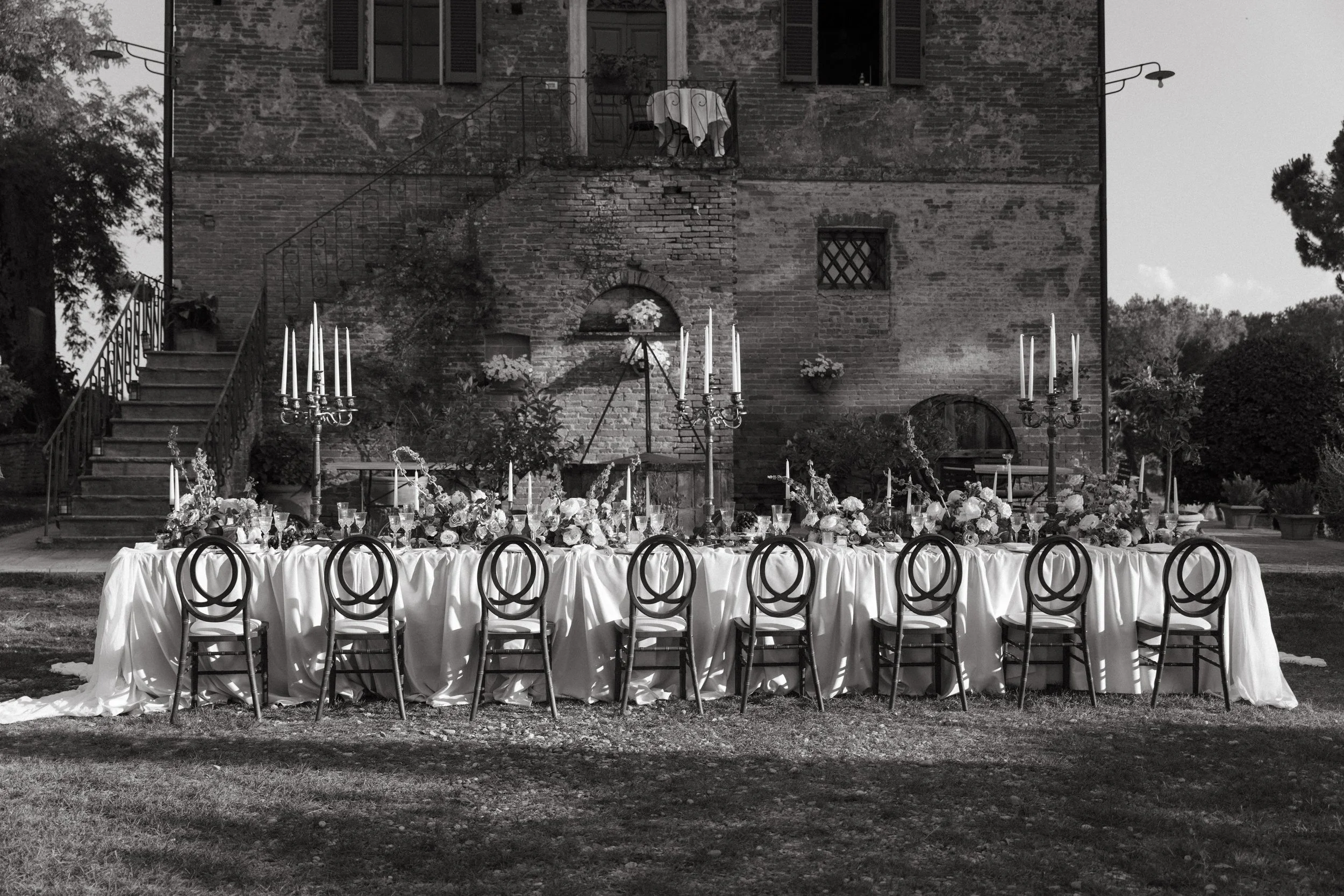 Intimate wedding reception set up at Villa Cozzano Tuscany with elegant table settings and floral arrangements