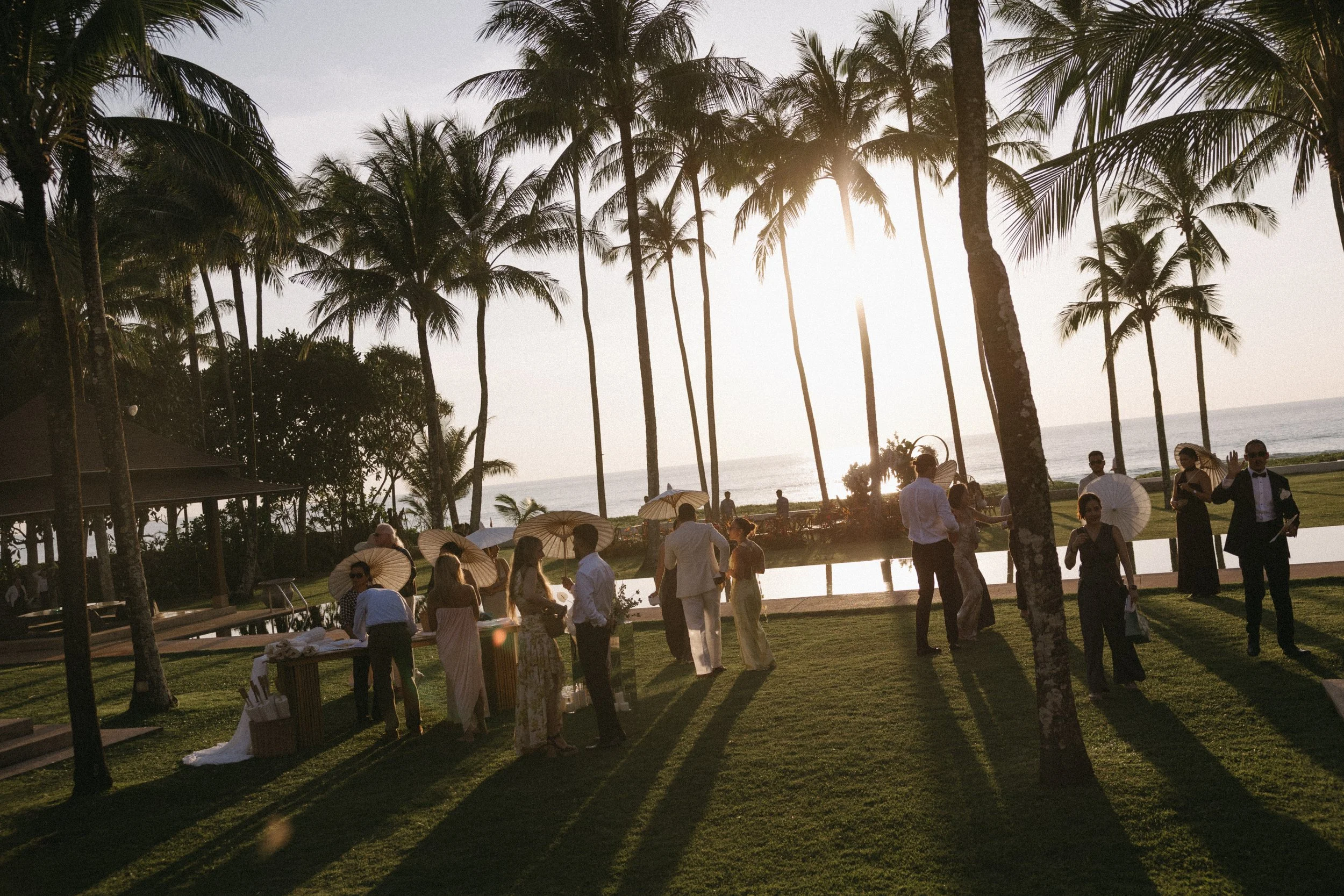 candid portrait of guests enjoying welcome drinks with beach in the background at jivana beach villas