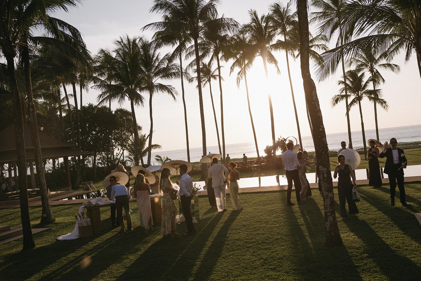 candid golden hour photo of guests at Phuket destination wedding