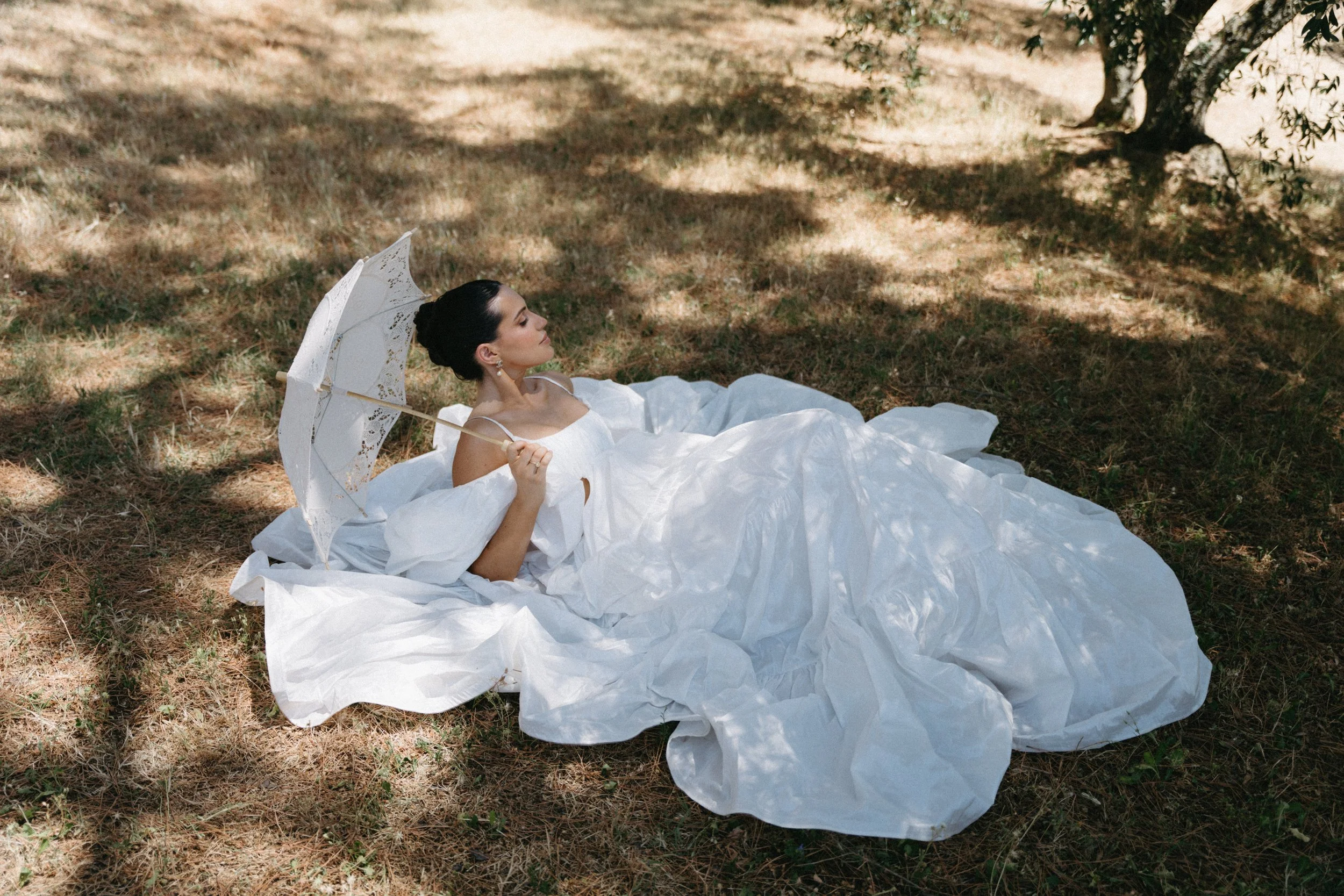 Bride in billowing white tiered dress with off-the-shoulder sleeves during Tuscany wedding editorial at Villa Cozzano