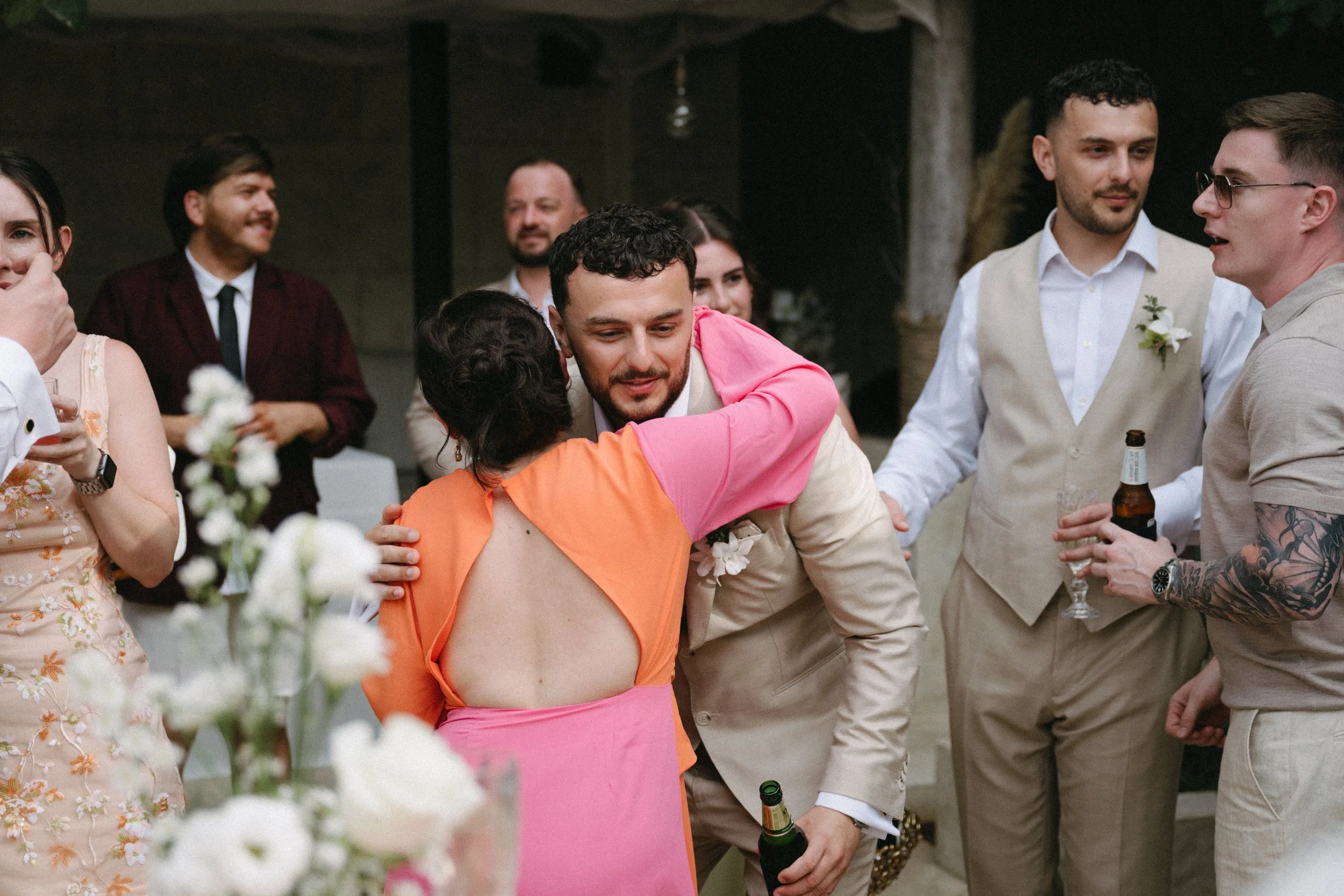 candid portrait of groom greeting guests at welcome drinks before wedding ceremony at odyssey mansion