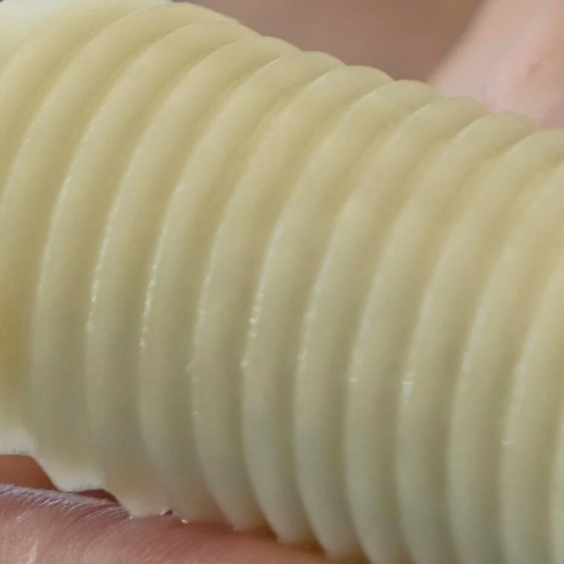 Close-up of a ridged potato slice being held.