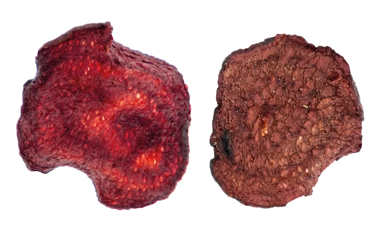 Close-up of two beet chips on a white background, displaying varying textures and coloration.