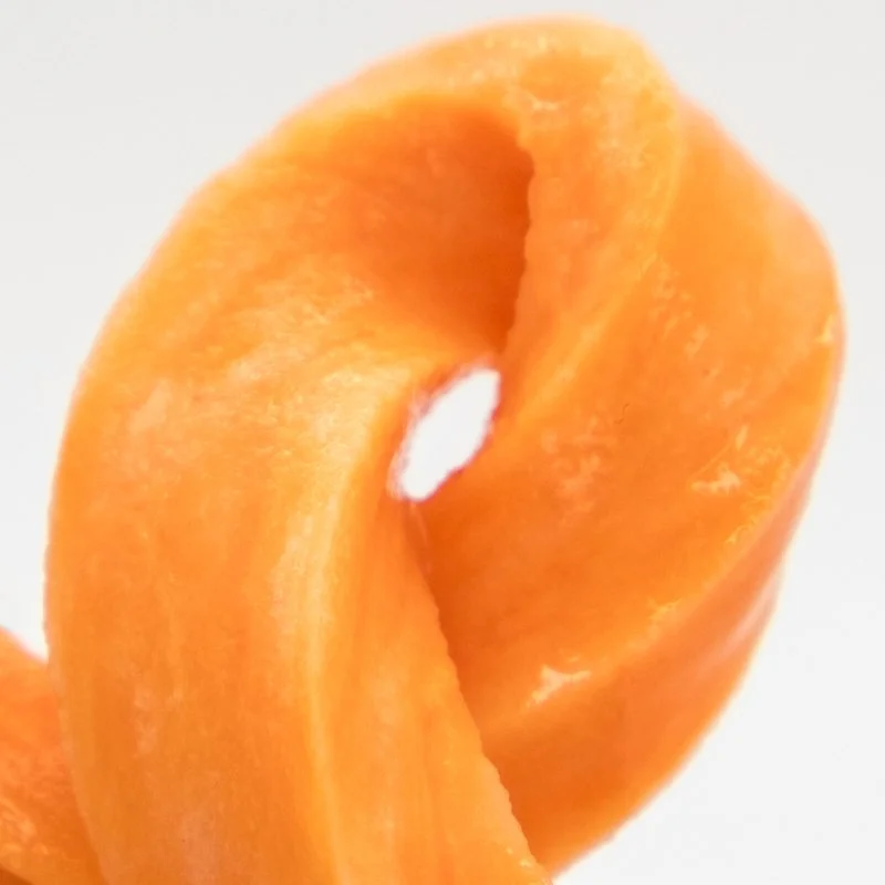 Close-up of an orange carrot curl on a white background.
