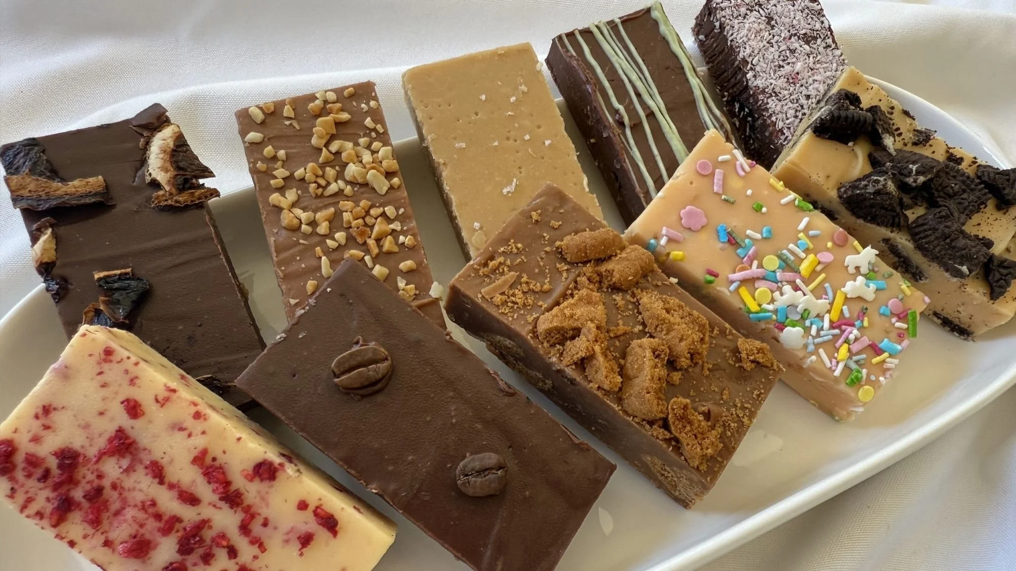 Selection of handmade Budgie Bakes fudge flavours on a serving platter