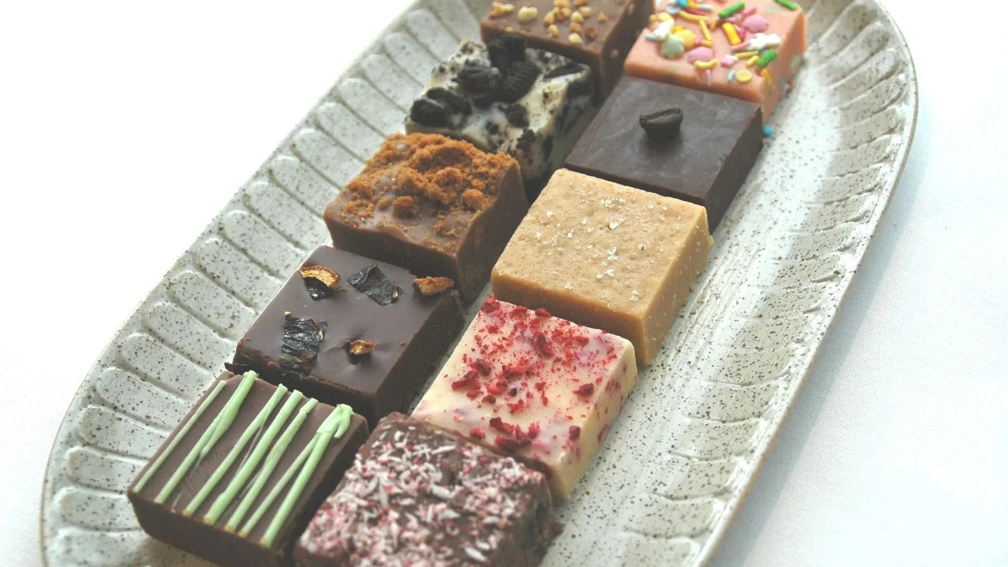 Selection of handmade Budgie Bakes fudge flavours on a tasting platter