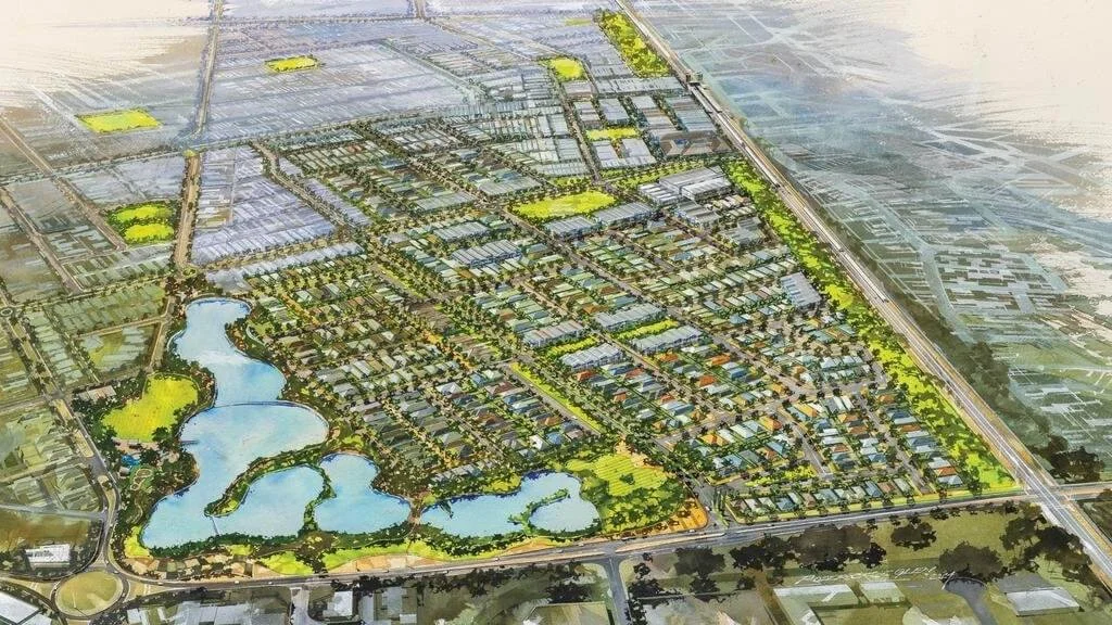 Aerial view of a planned community with lakes, parks, and residential areas.