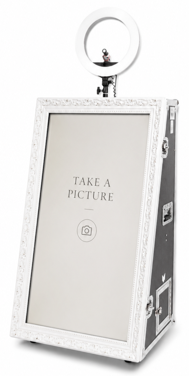 Photo of a photo booth with a sign that says "Take a Picture" and a ring light on top for taking selfies.