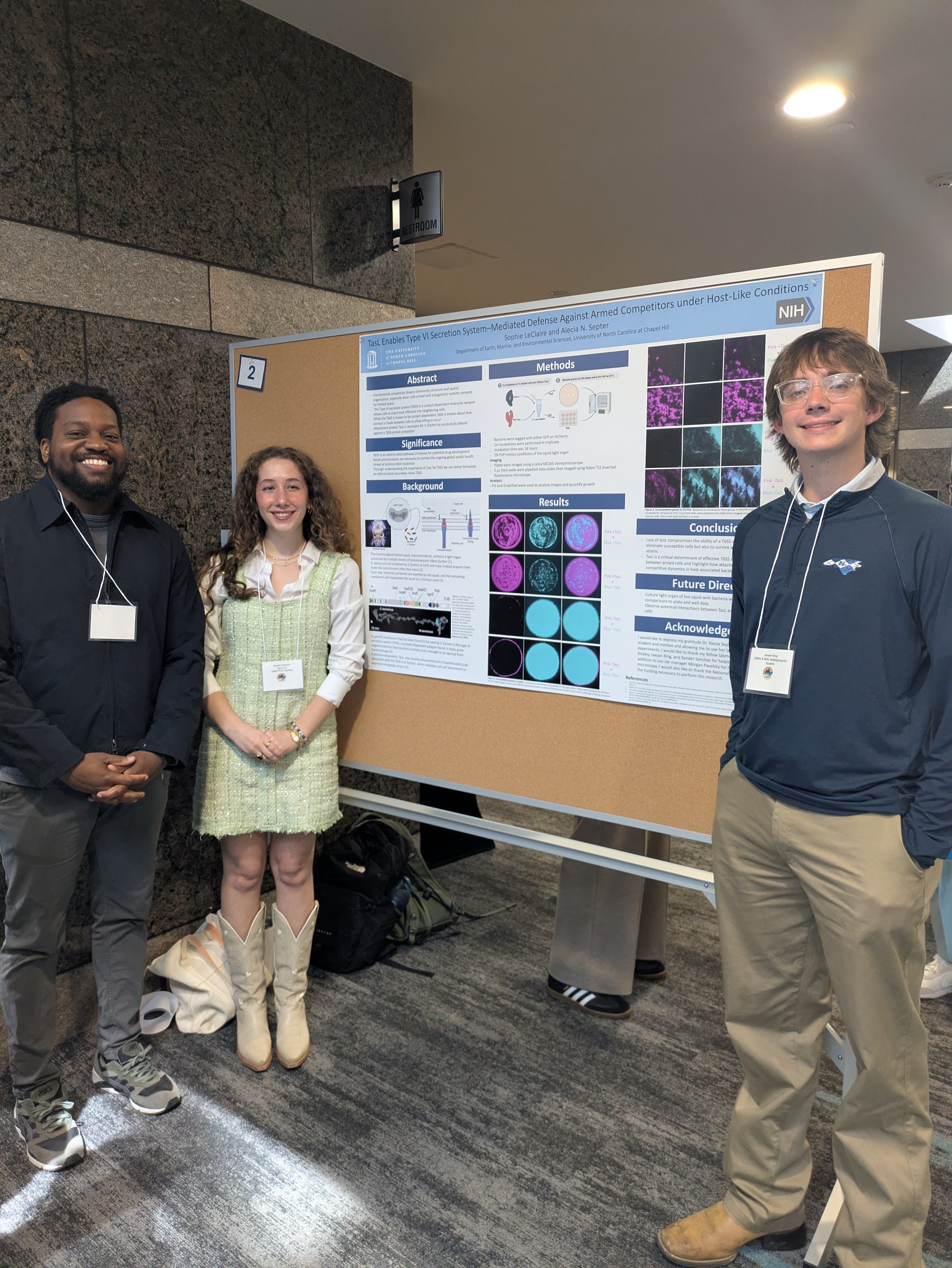 Aundre and Jaxson support lab mate and grad student Sophie Leclaire at her poster at the UNC EMES student research symposium 2026