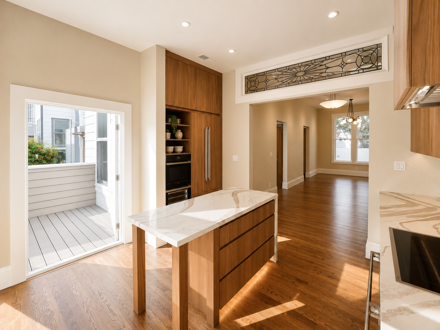 Modern walnut kitchen renovation featuring full-height wood cabinetry, waterfall quartz island, integrated appliances, and natural light in a san francisco residential remodel by From David Designs.