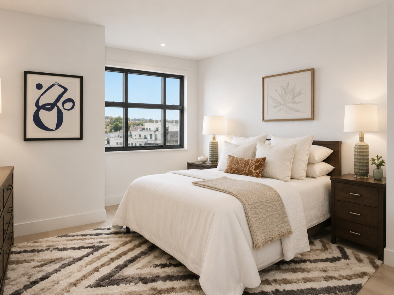 This bedroom design creates a soft, calming retreat with warm neutral tones, layered bedding, dark wood furniture, textured rugs, framed artwork, and balanced bedside lighting. The black frame window adds contrast while keeping the overall space brig