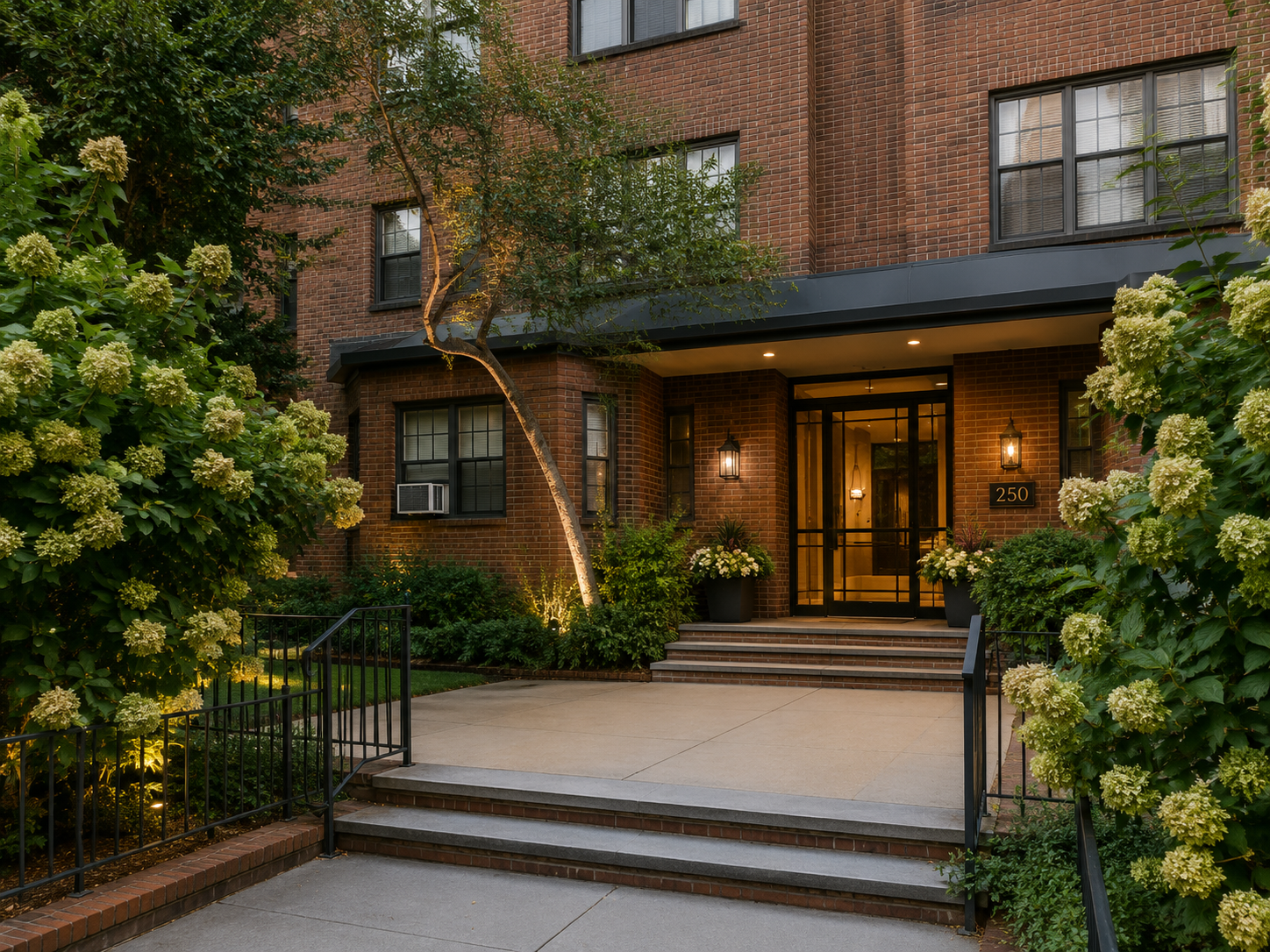 This Brooklyn residential renovation reimagines the building entrance with new architectural lighting, enhanced landscaping, and a refined entry sequence. Framed by mature hydrangeas, brick detailing, and contemporary black metal accents, the design 