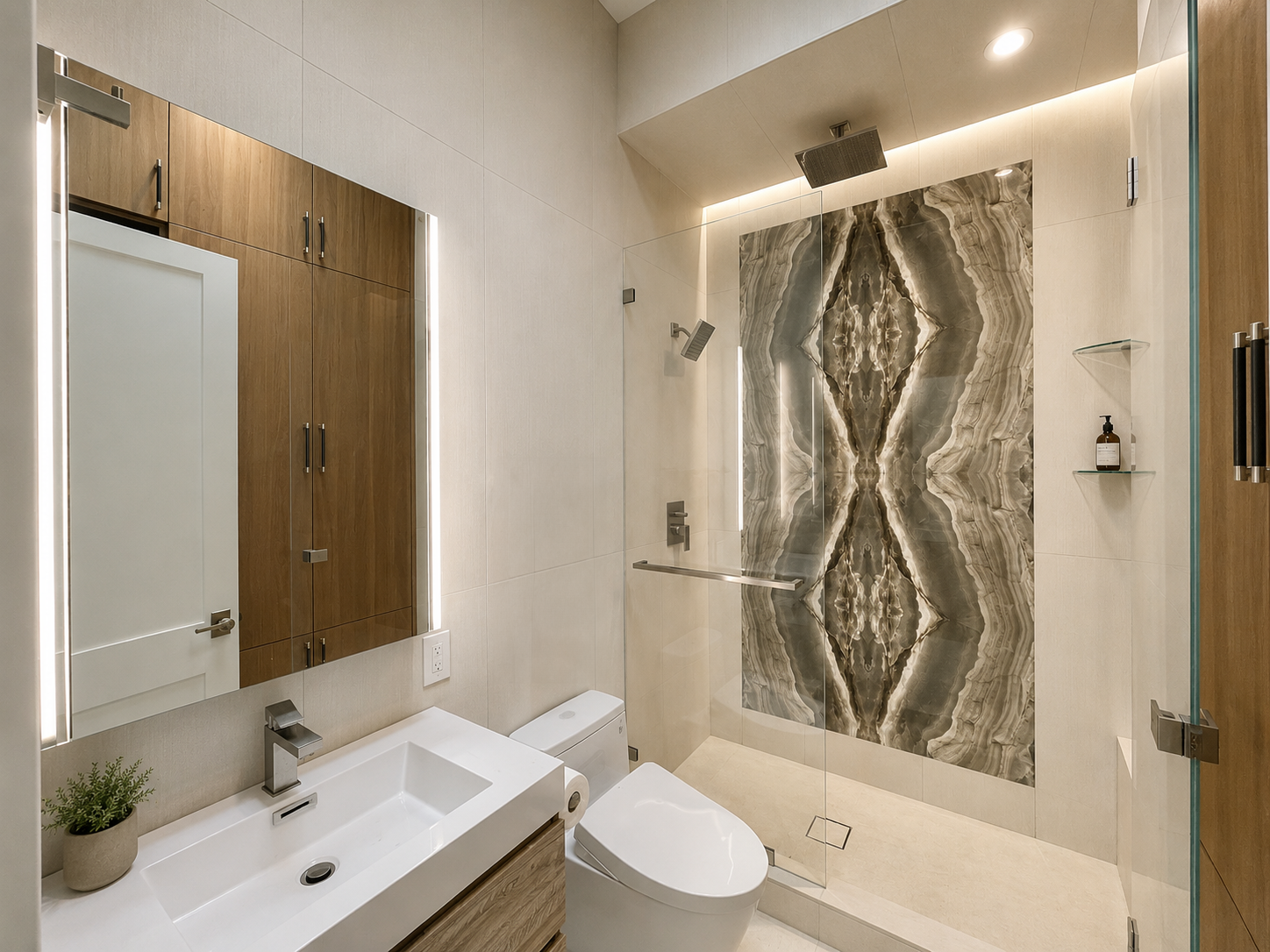 Modern bathroom with marble accent wall in walk-in shower, glass door, wooden cabinetry, white sink, small plant, and a toilet.