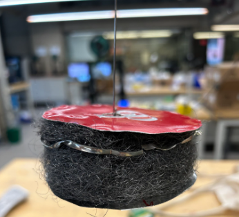Makeshift piston out of the tops of the bigger can and inserting steel wool to trap heat