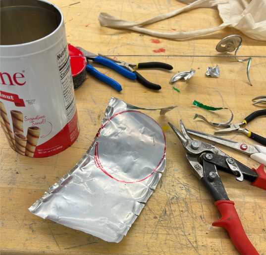 The beginning process: creating sheets of metal by opening up soda cans