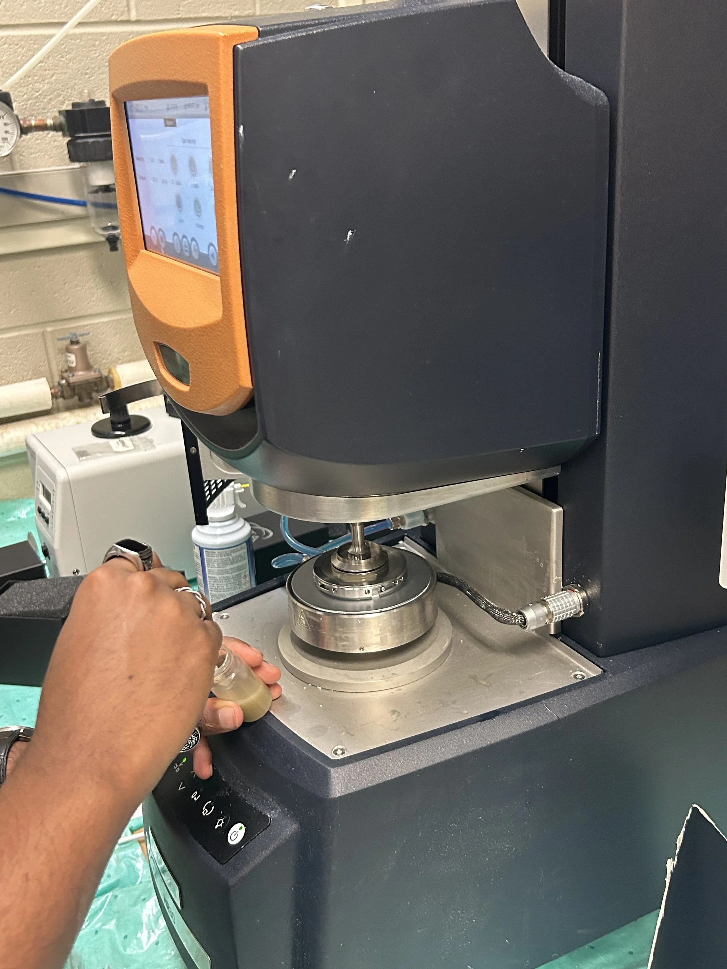 Group-mate pouring sample into the Rheometer
