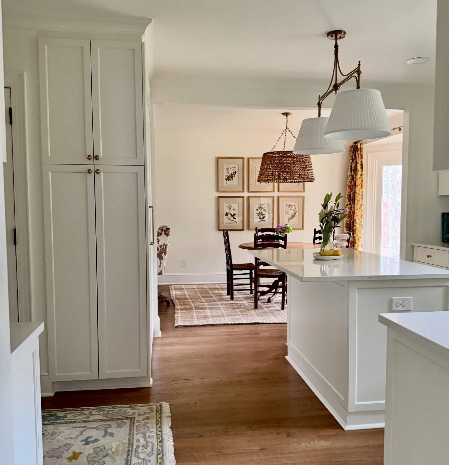 Before + after kitchen renovation in Charlotte, NC ➡️ Fresh floors, cabinets, lighting, appliances, hardware. Knocked down and restructured a few walls -  added a walk-in pantry and straightened out the angled corner wall with a narrow storage cabine