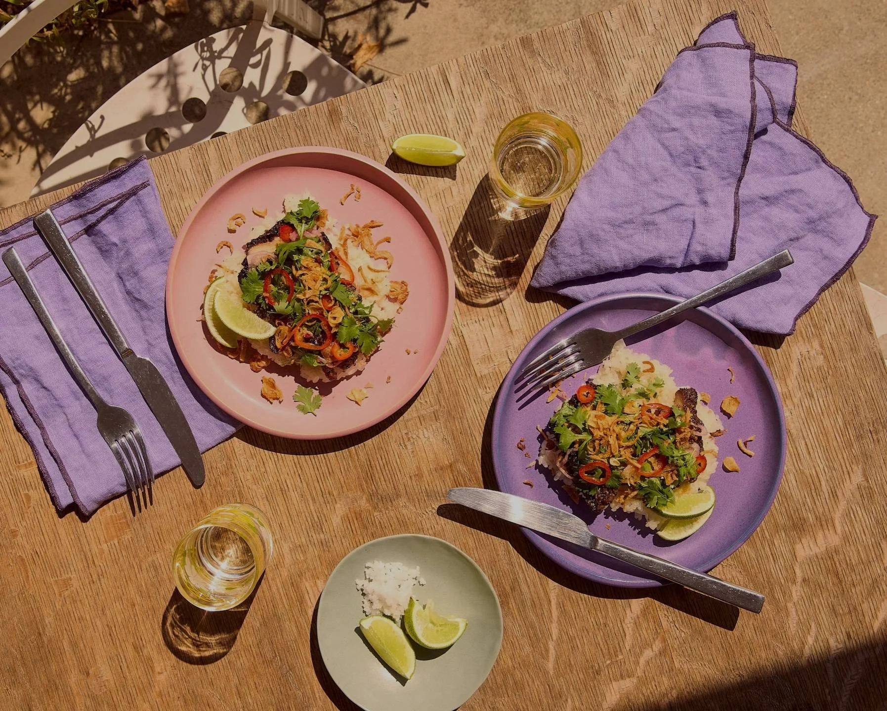 Overhead shot of Savory Scallion dishes on pink and lavender plates with lime and linen napkins