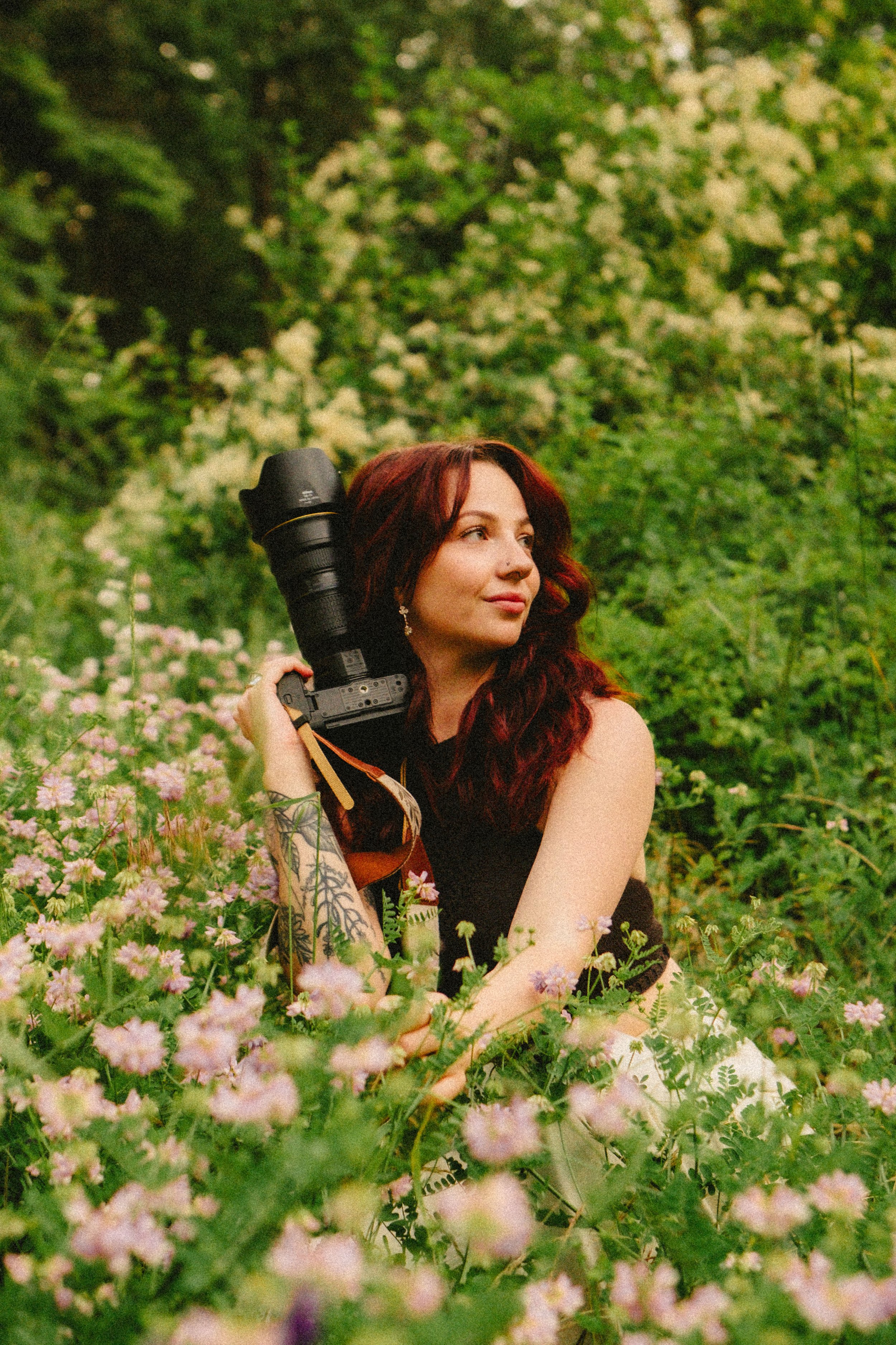 Creative personal branding portrait of a photographer in a field of flowers in New Mexico.