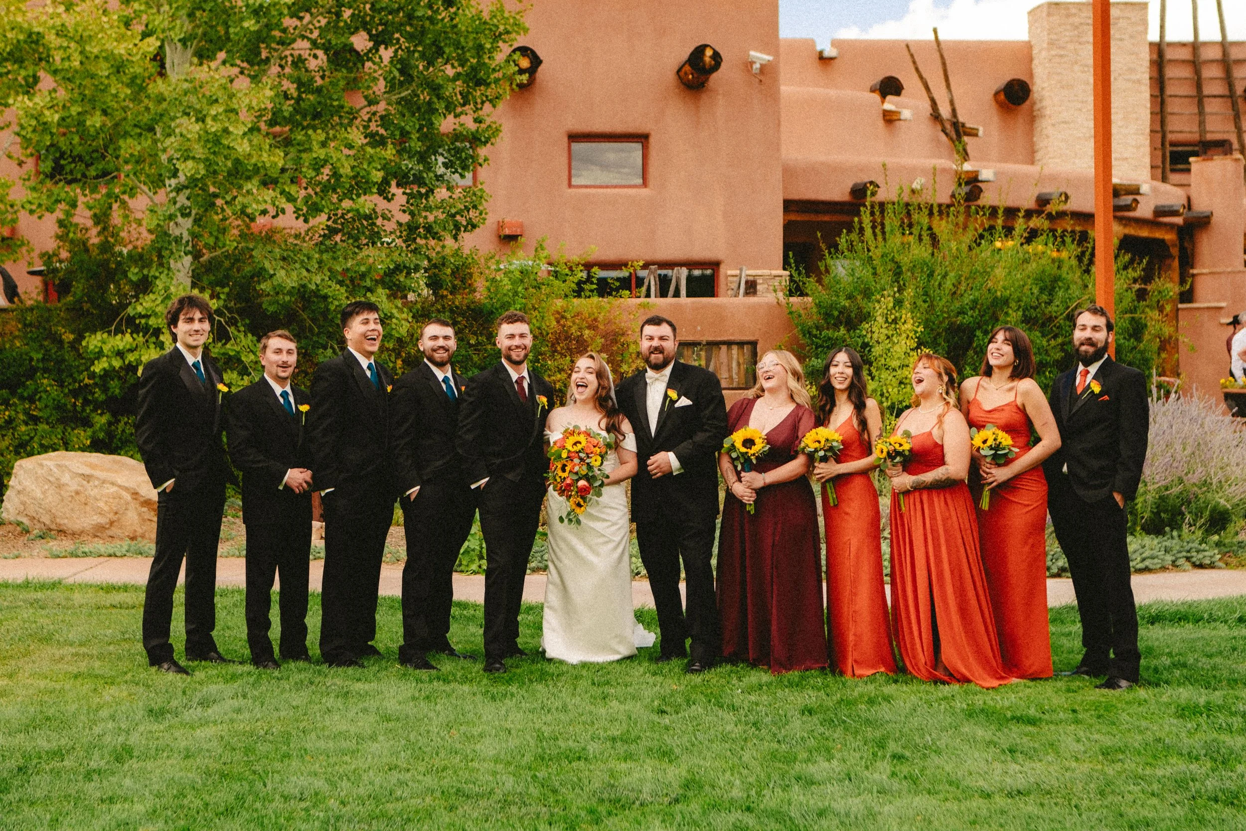 Wedding party posing together outdoors during a New Mexico wedding.
