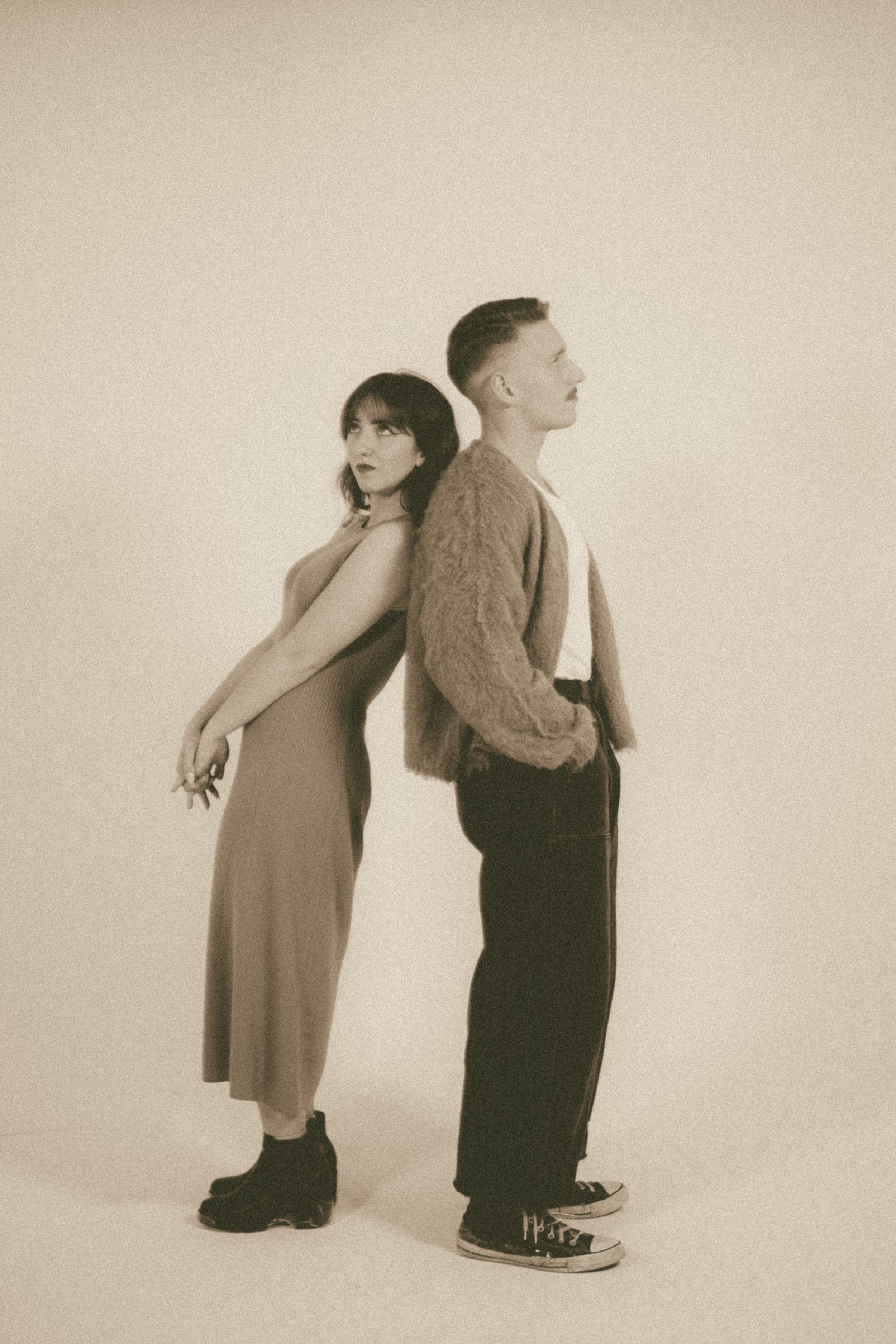 Couple posing back-to-back during a cinematic portrait session in Albuquerque, New Mexico.