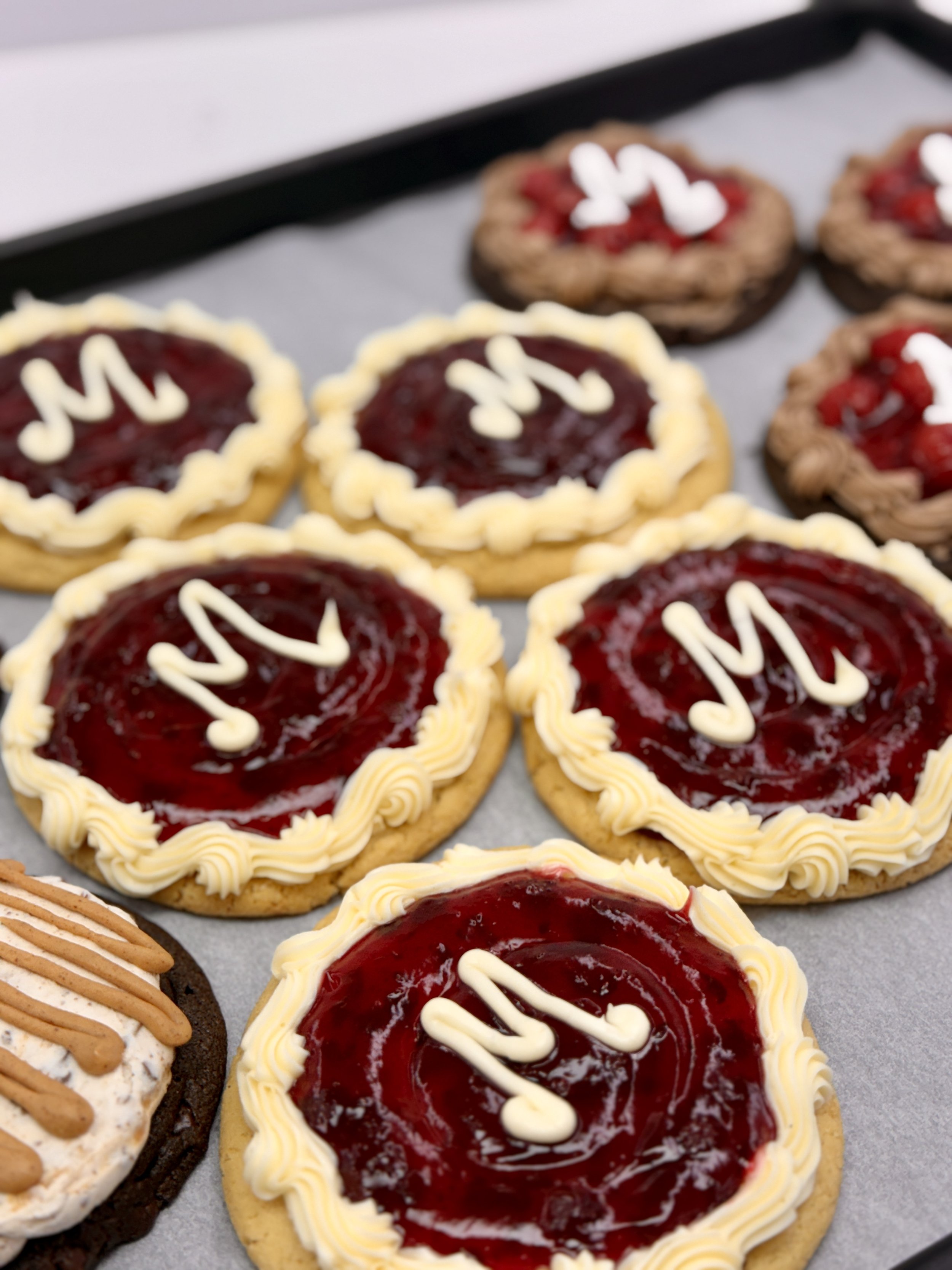 Close-up of assorted decorated cookies on a tray.